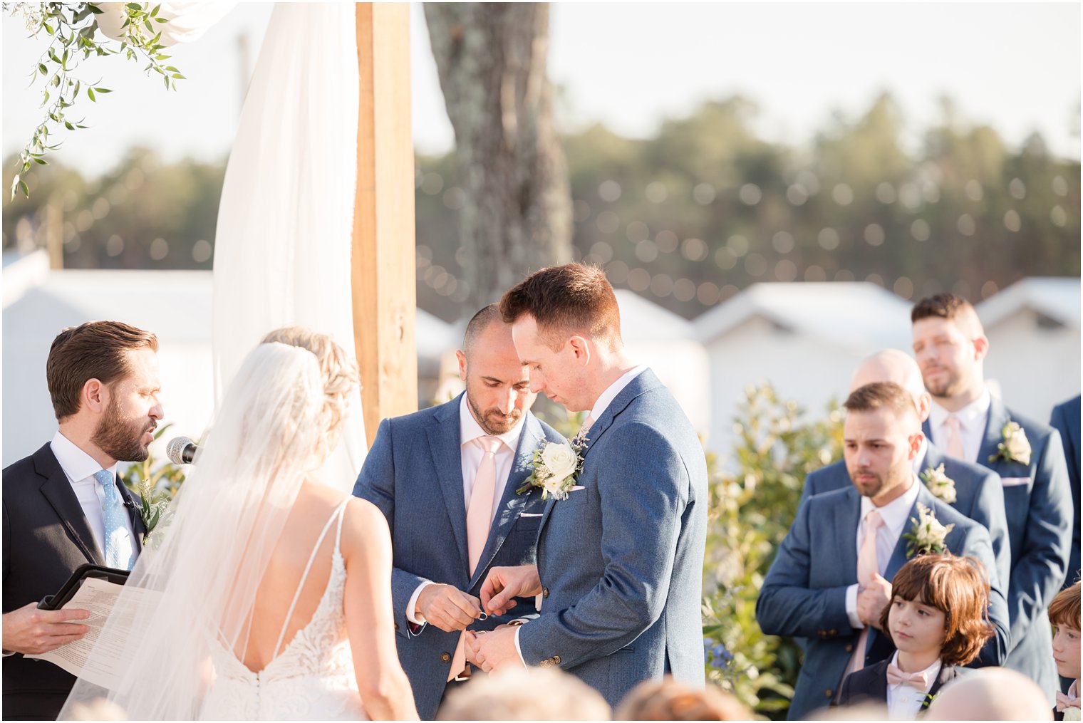 ring exchange during outdoor ceremony at Renault Winery in Egg Harbor Township, NJ