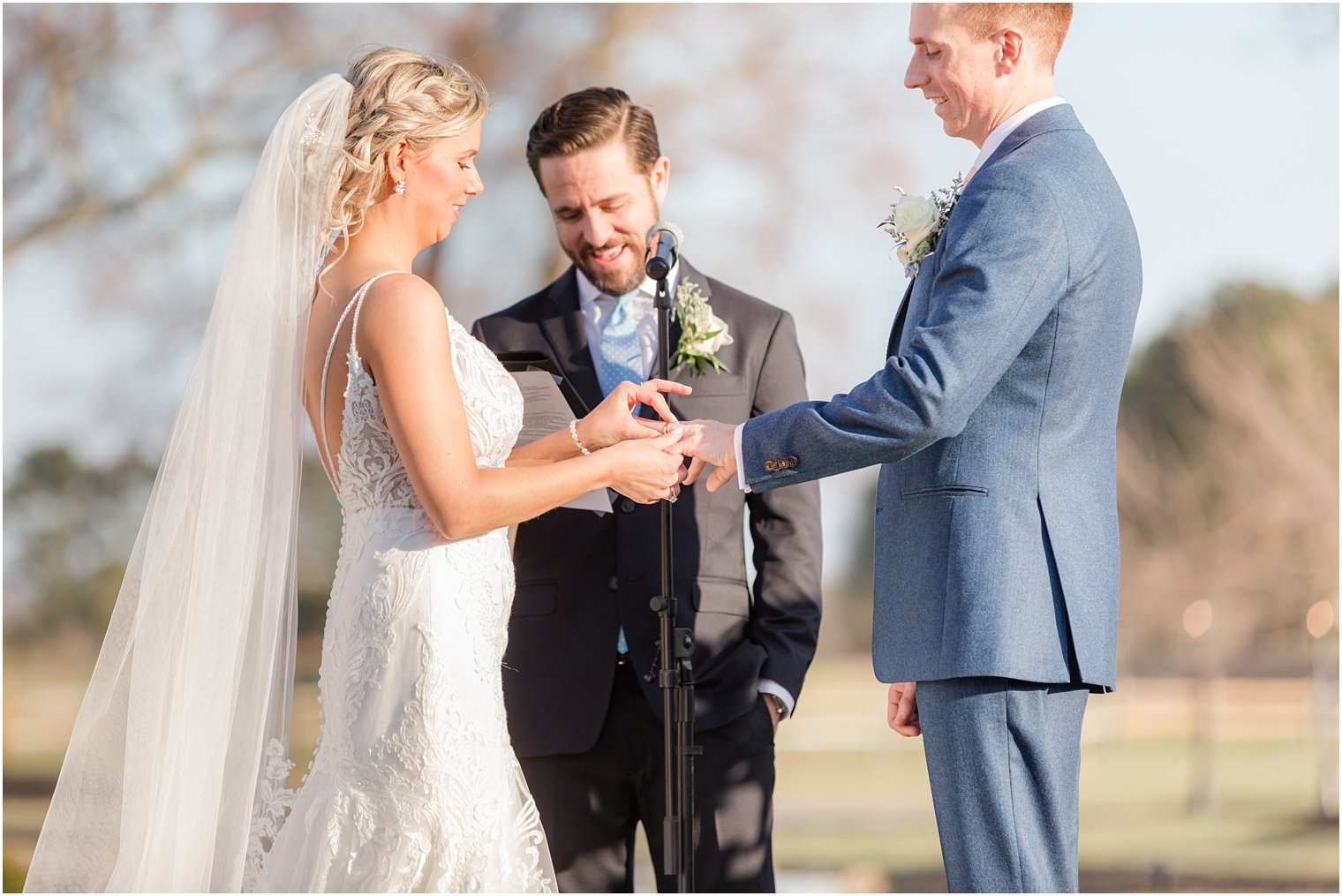 ring exchange during outdoor ceremony at Renault Winery in Egg Harbor Township, NJ