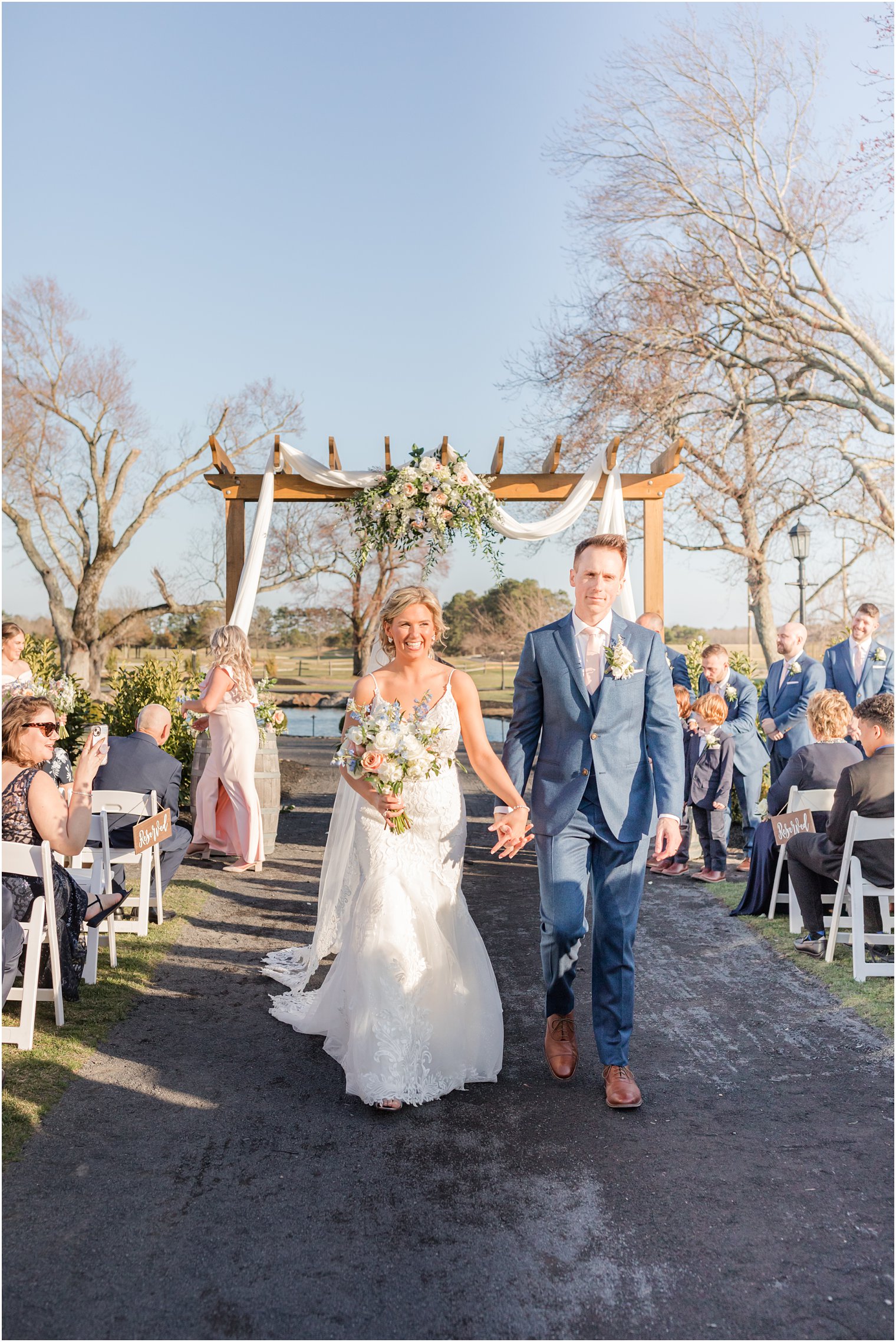 bride and groom walking down the aisle during outdoor ceremony at Renault Winery in Egg Harbor Township, NJ