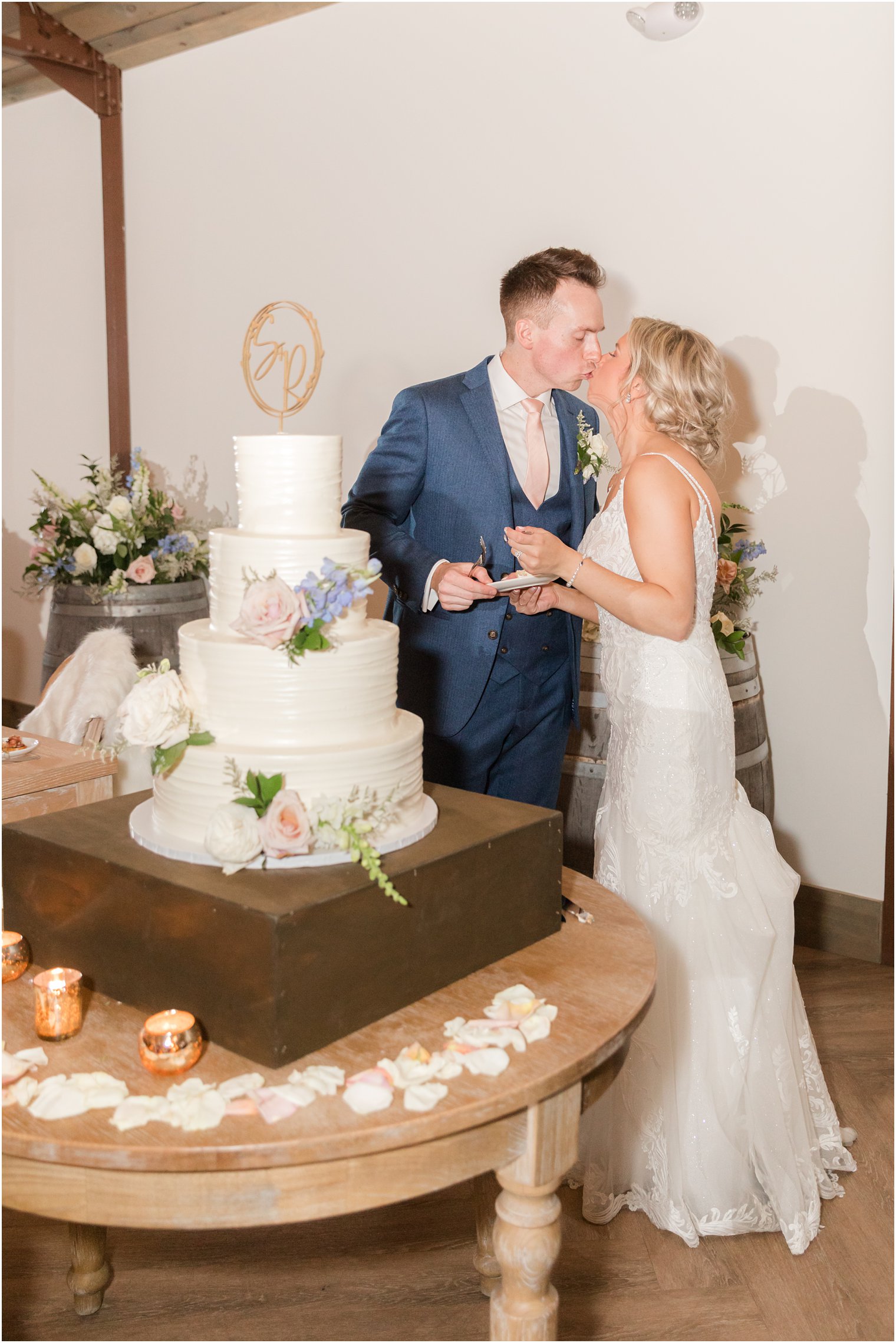 bride and groom cutting cake at rustic wedding reception in Vineyard Ballroom at Renault Winery South Jersey Venue in Egg Harbor Township NJ