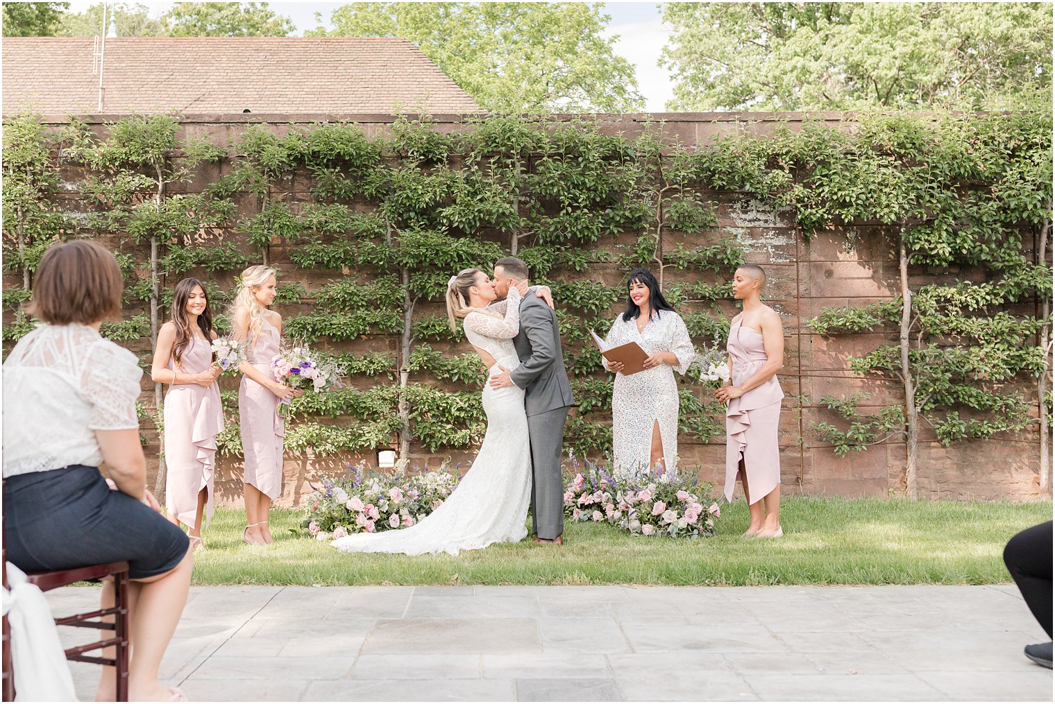 bride and groom kiss during Croatian inspired minimony at Tyler Gardens