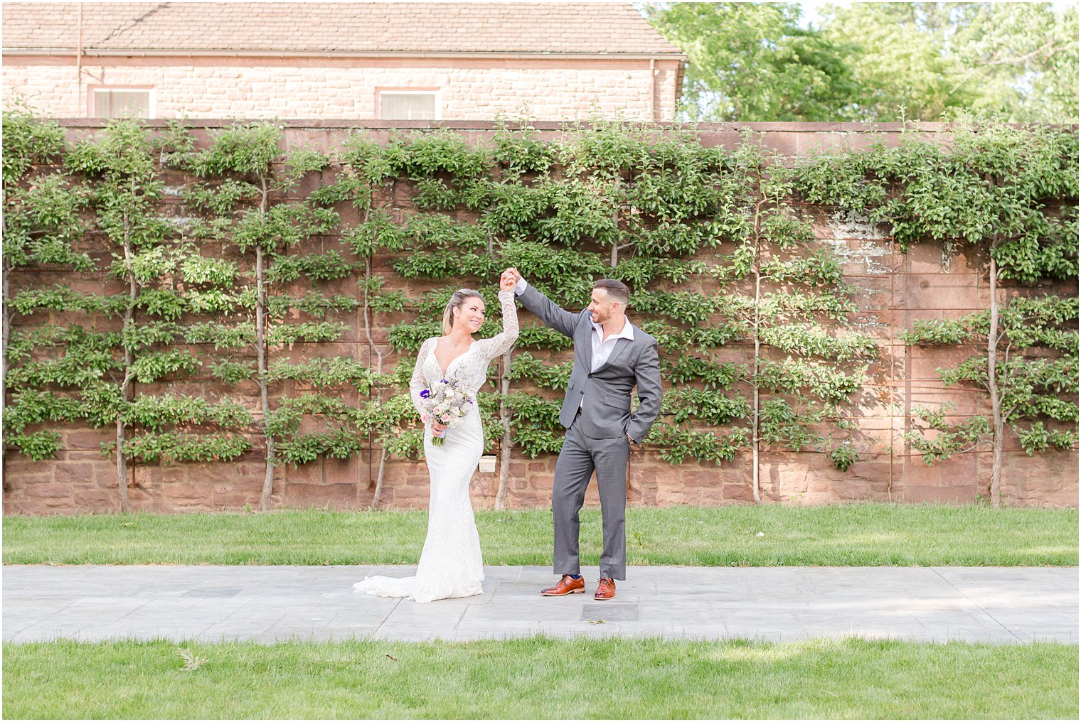 groom twirls bride during portraits in Tyler Gardens