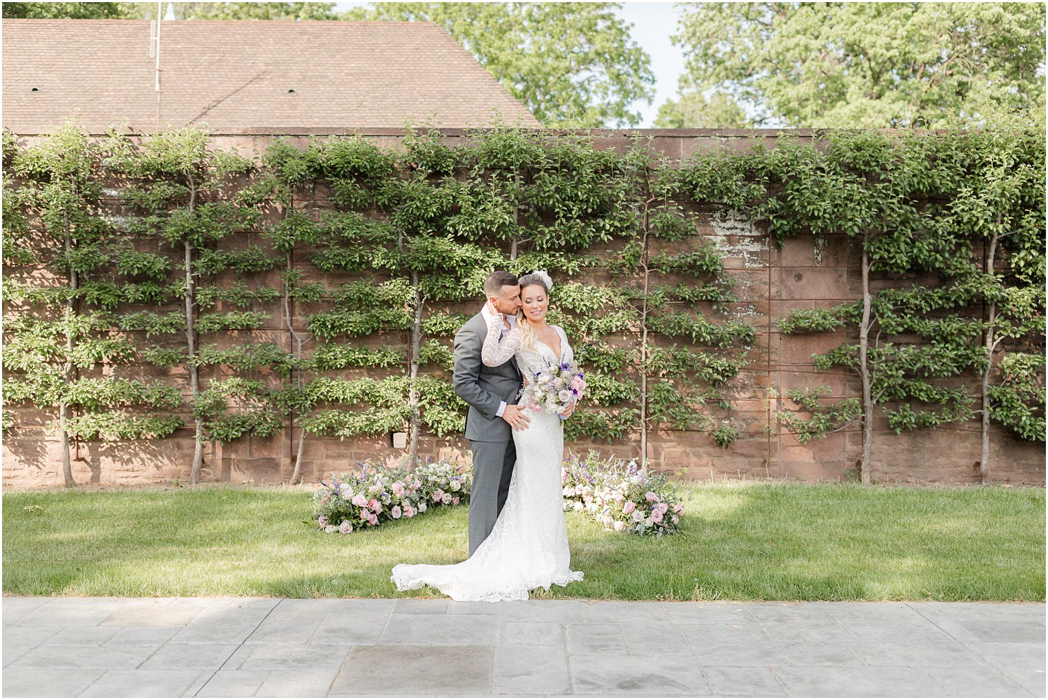 groom hugs bride from behind during Croatian inspired minimony at Tyler Gardens