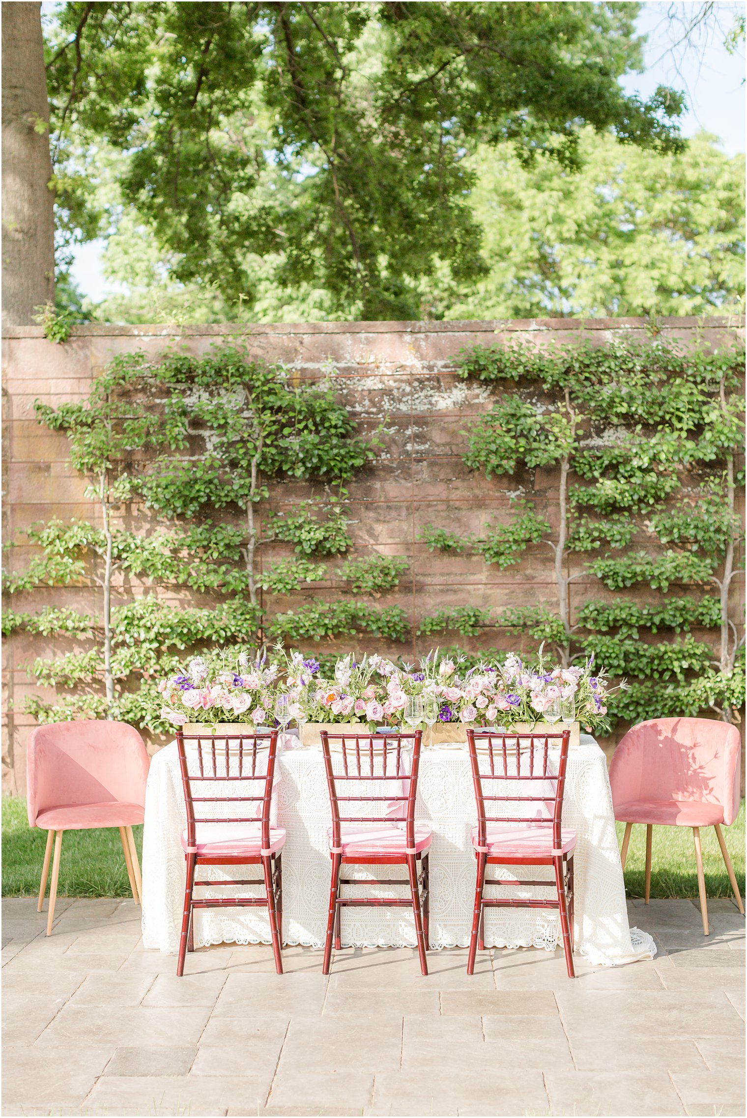 garden wedding reception with pastel pink and purple floral centerpiece at Tyler Gardens