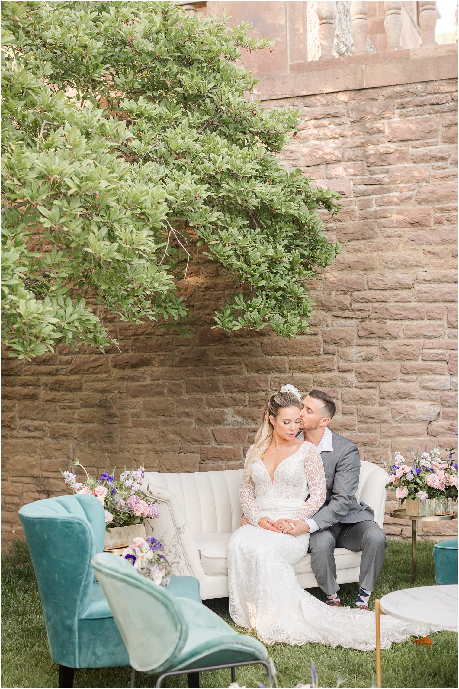newlyweds sit on couch during reception in Tyler Gardens