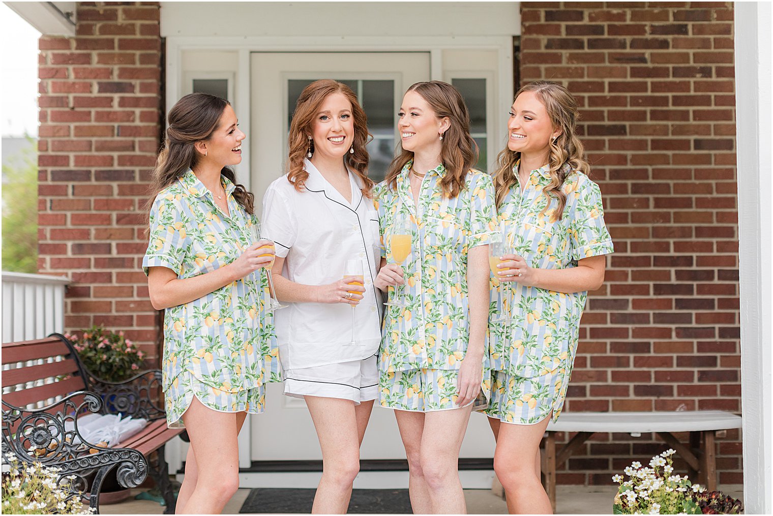 bride stands with bridesmaids in matching green pajamas before NJ wedding