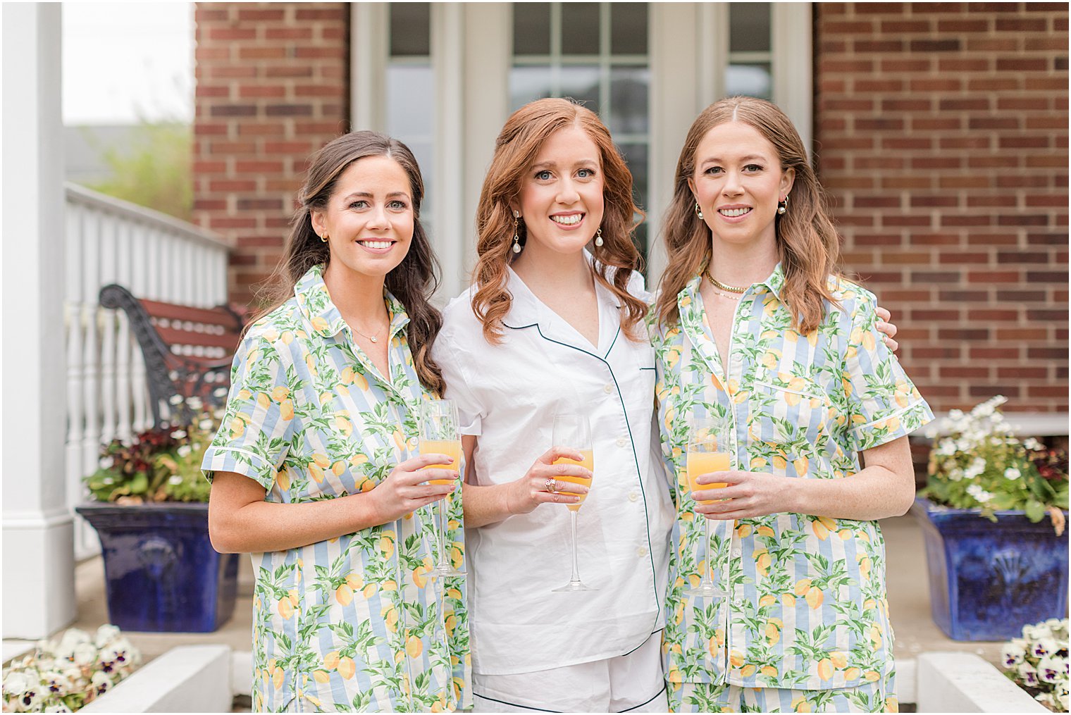 bride poses with bridesmaids outside Belmar NJ home