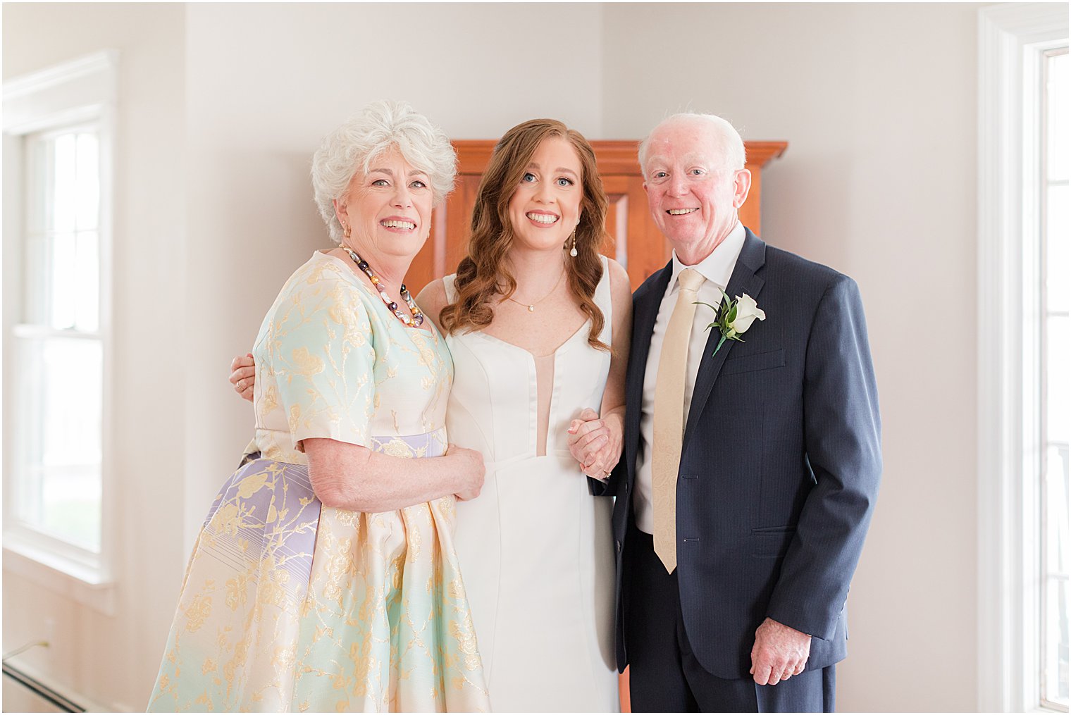 bride and parents pose together in NJ home