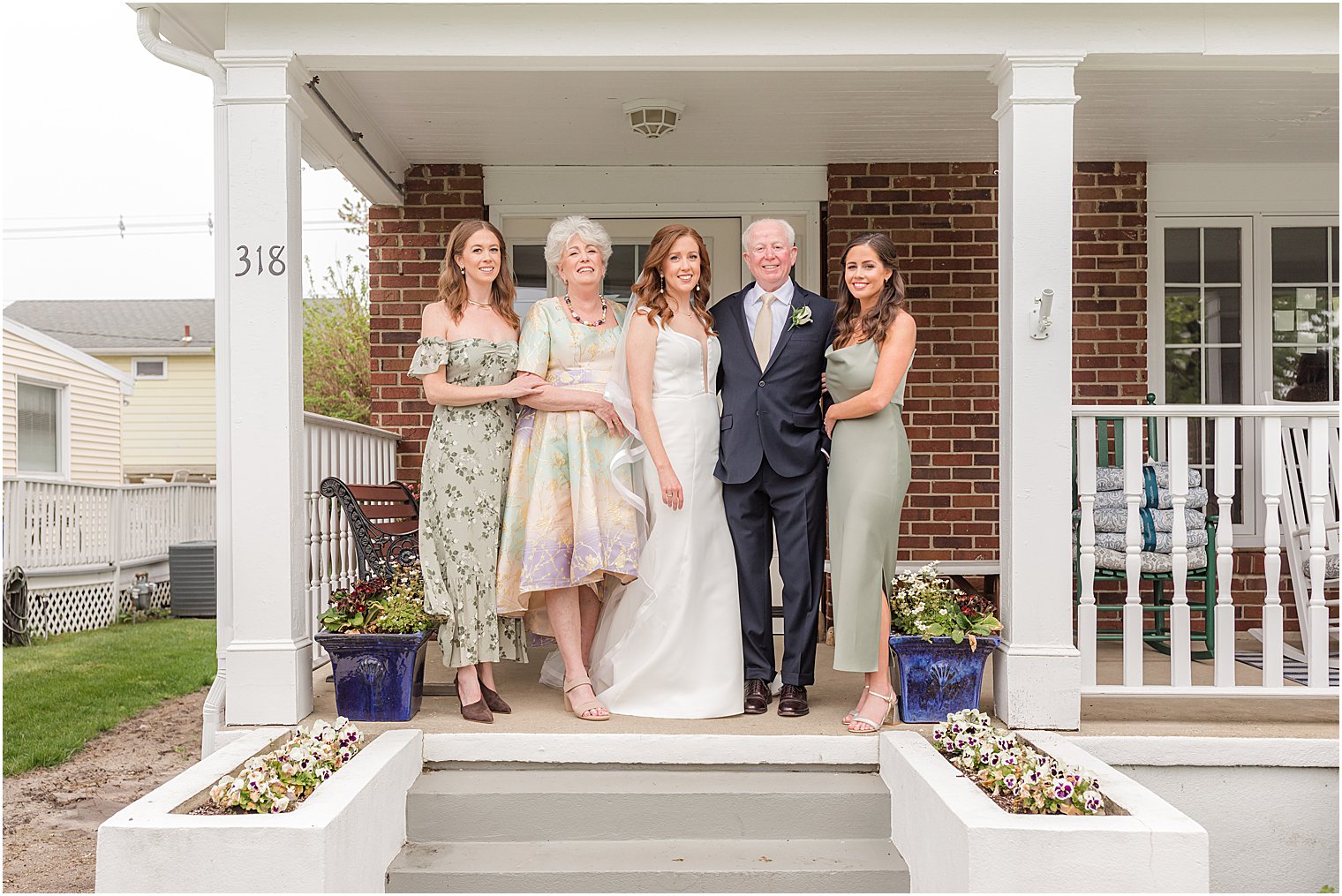 bride stands with family on porch of Belmar nJ home