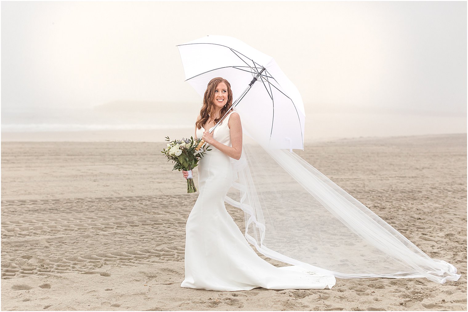 bride walks under umbrella during rainy wedding photos