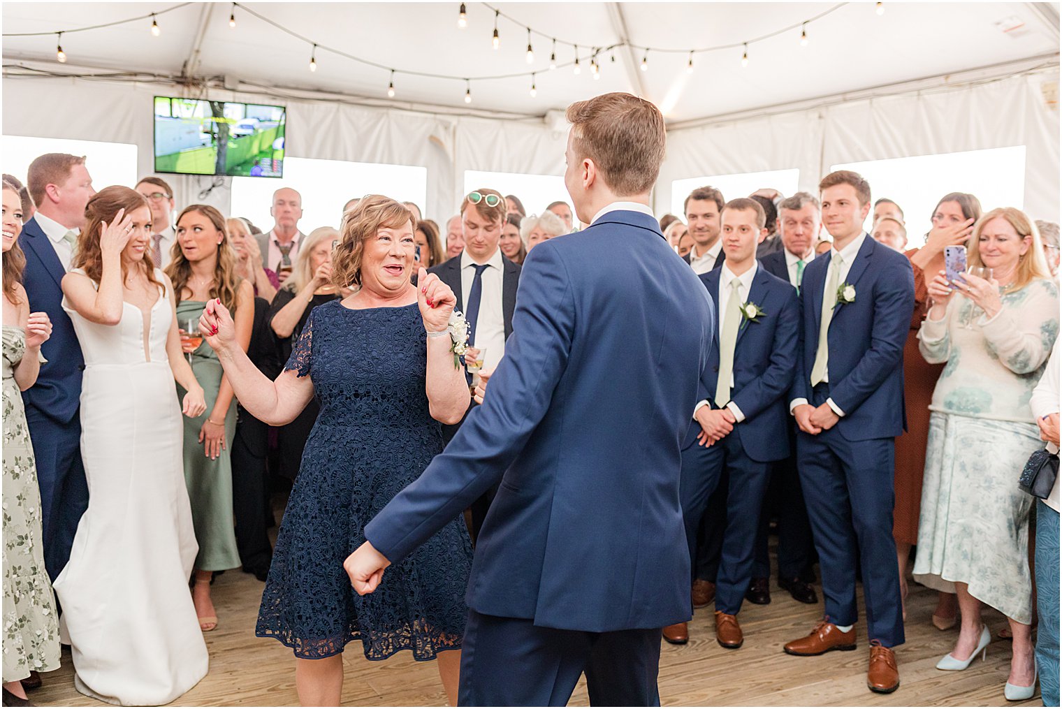 groom twirls mom out onto dance floor 