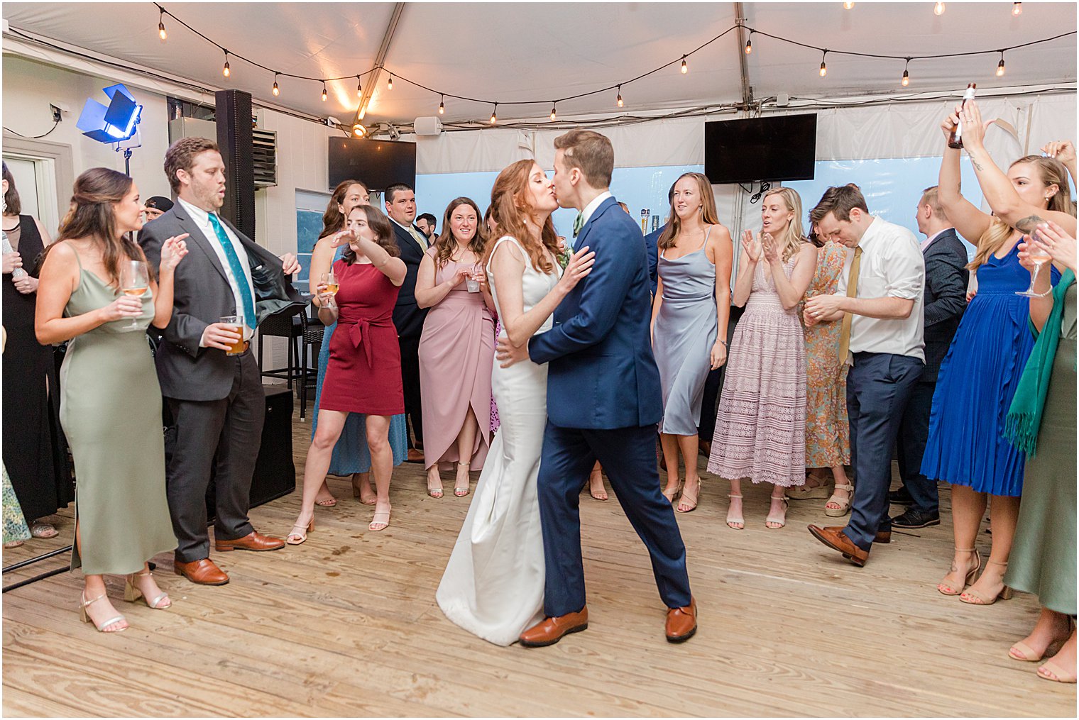 bride and groom kiss on dance floor during Belmar NJ wedding reception