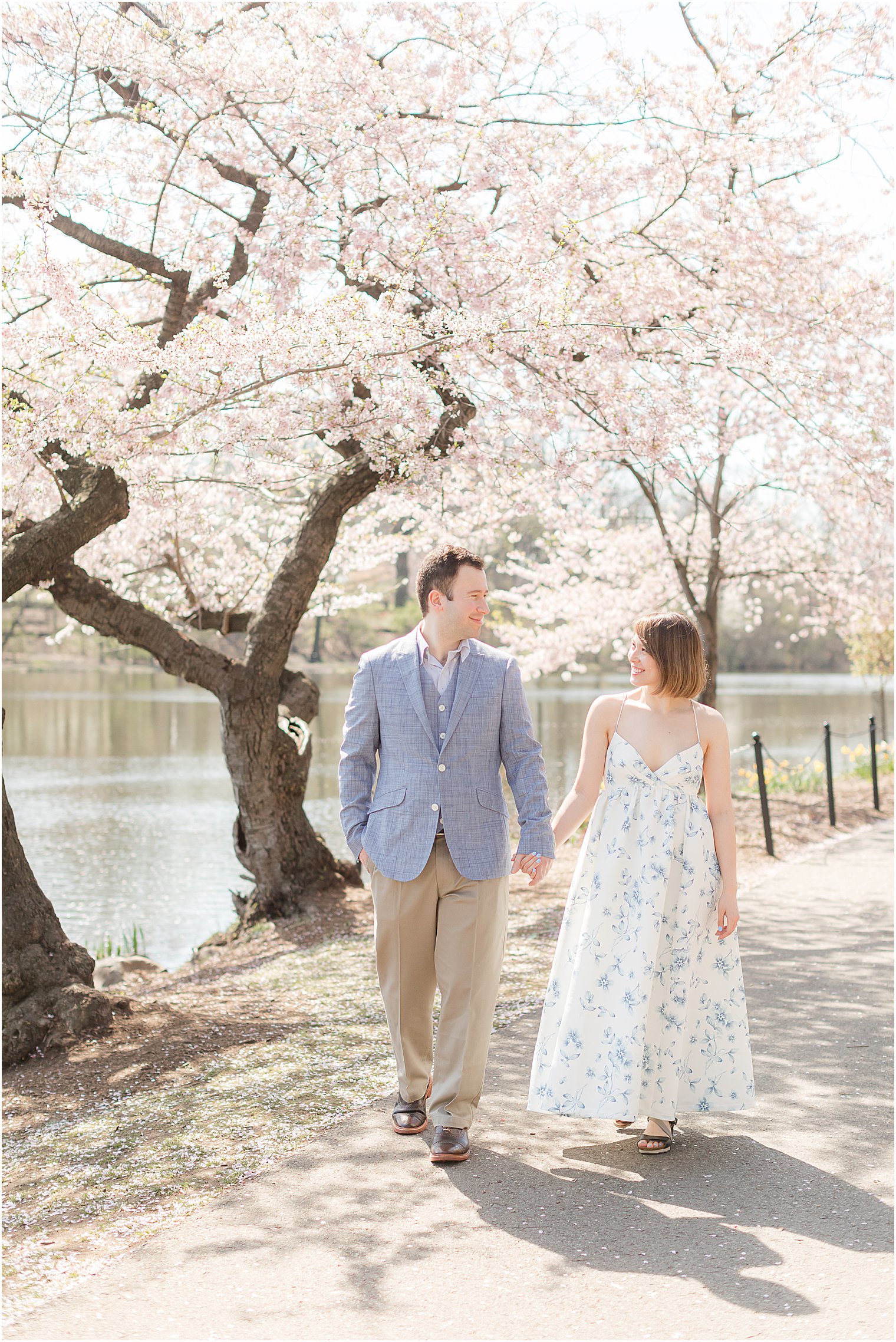 engaged couple walks through Branch Brook Park