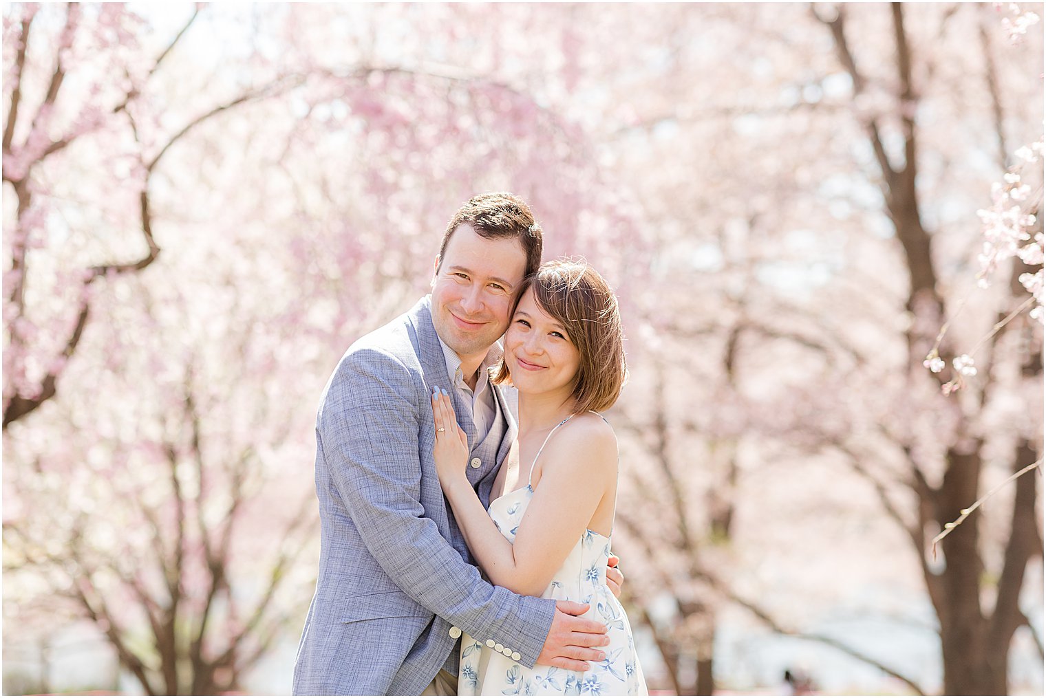 bride and groom hug together during spring engagement photos at Branch Brook Park