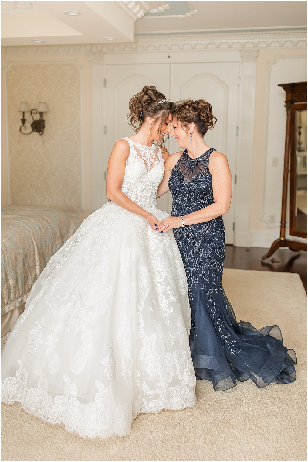 mother of the bride with her daughter getting ready for wedding day