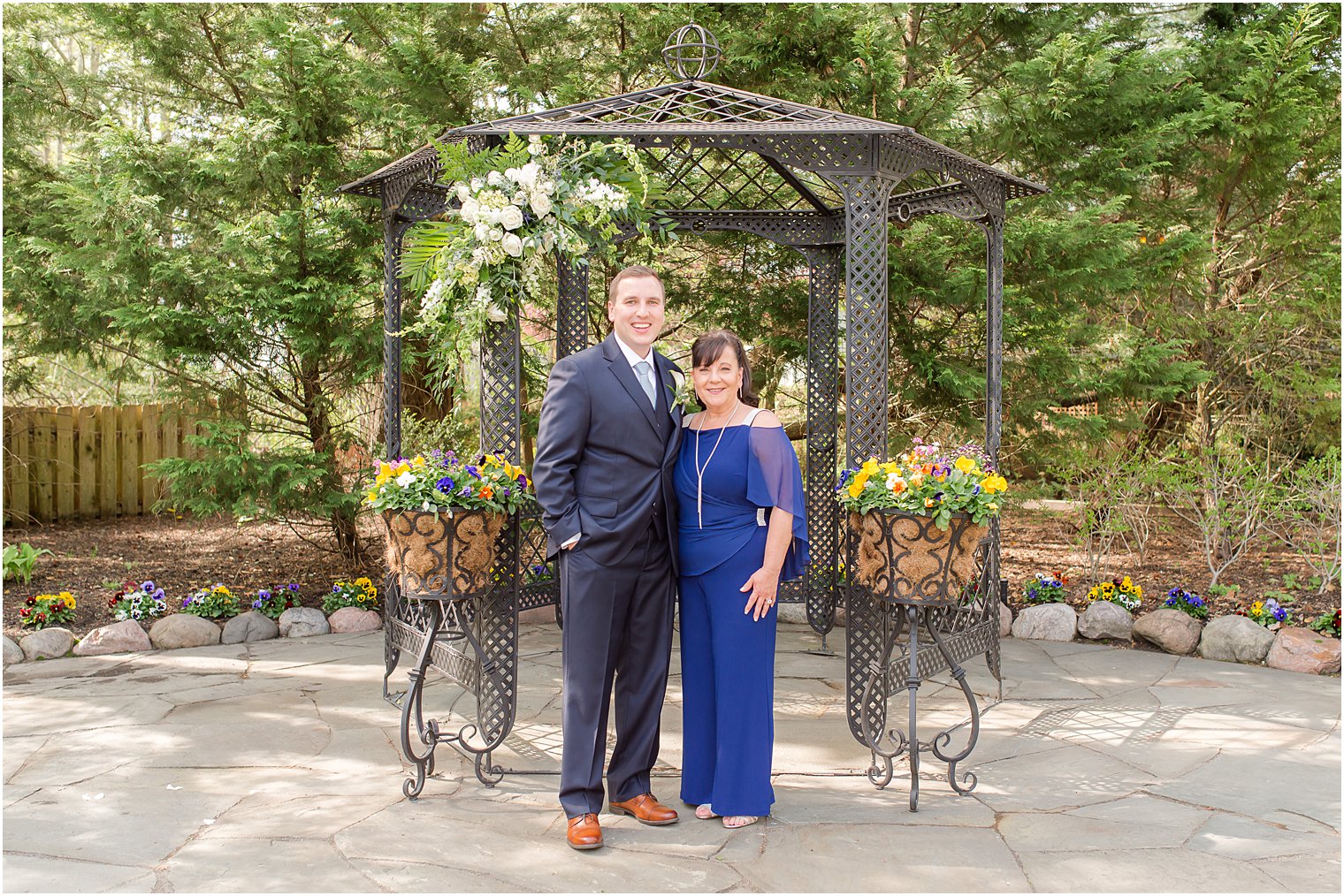 mother and son under gazebo for family formals on wedding day