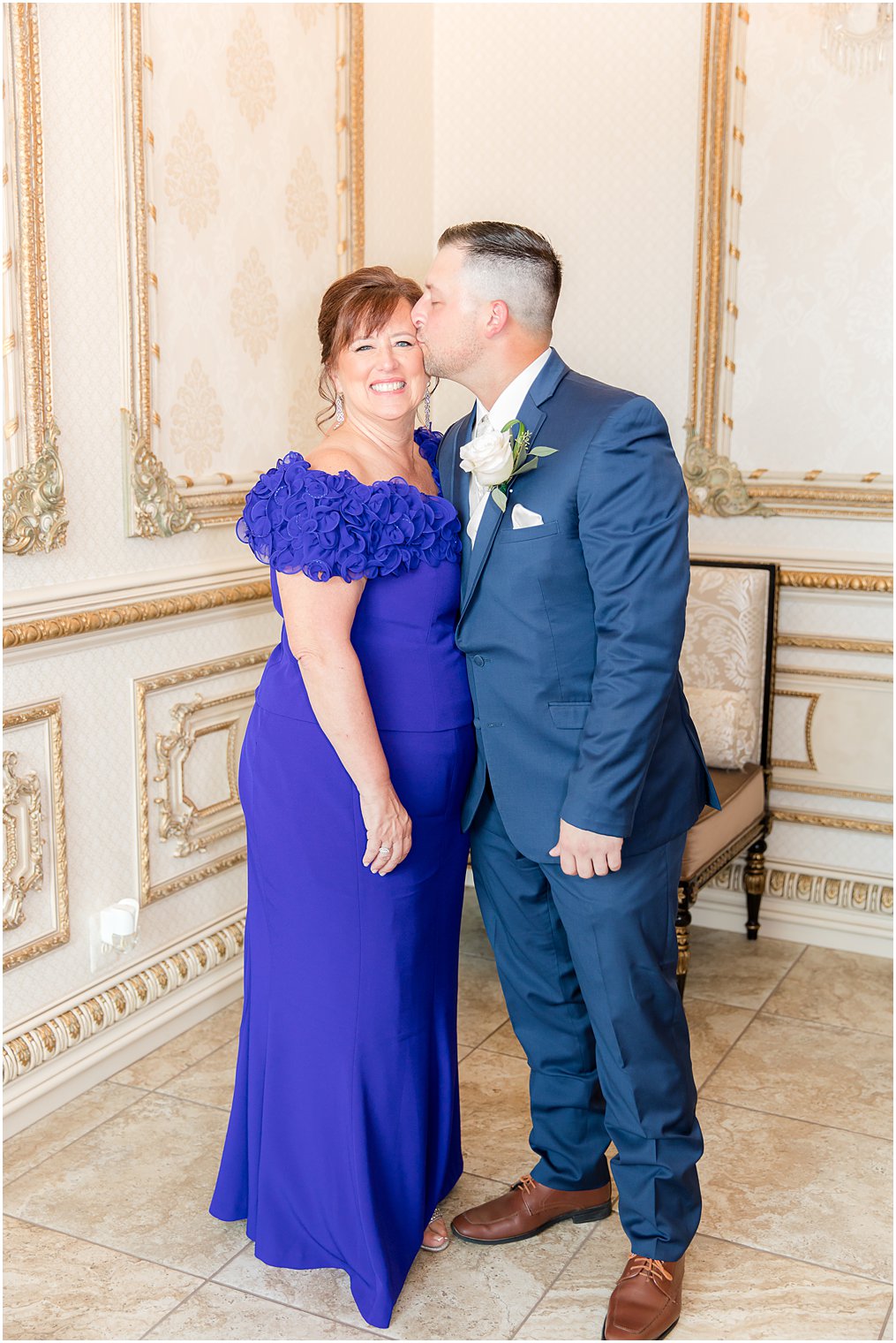 son kisses his mom on the cheek on his wedding day