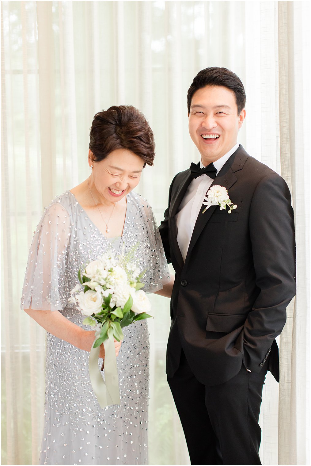 mother and son share a laugh together before wedding