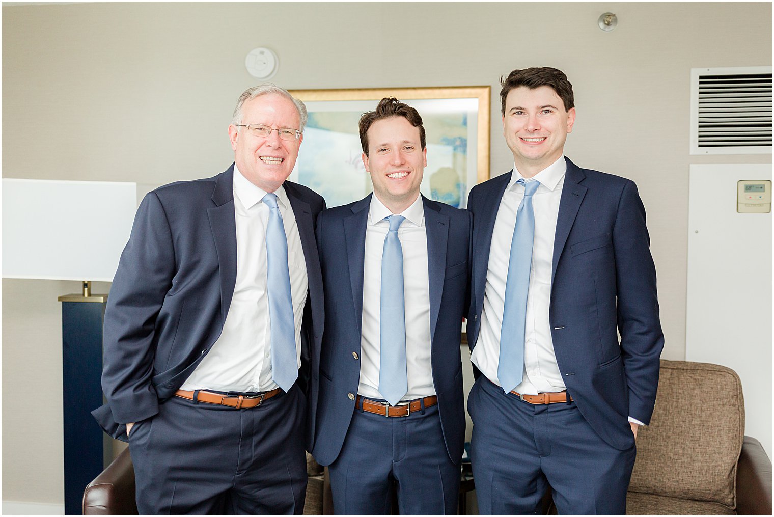 groom poses with dad and brother