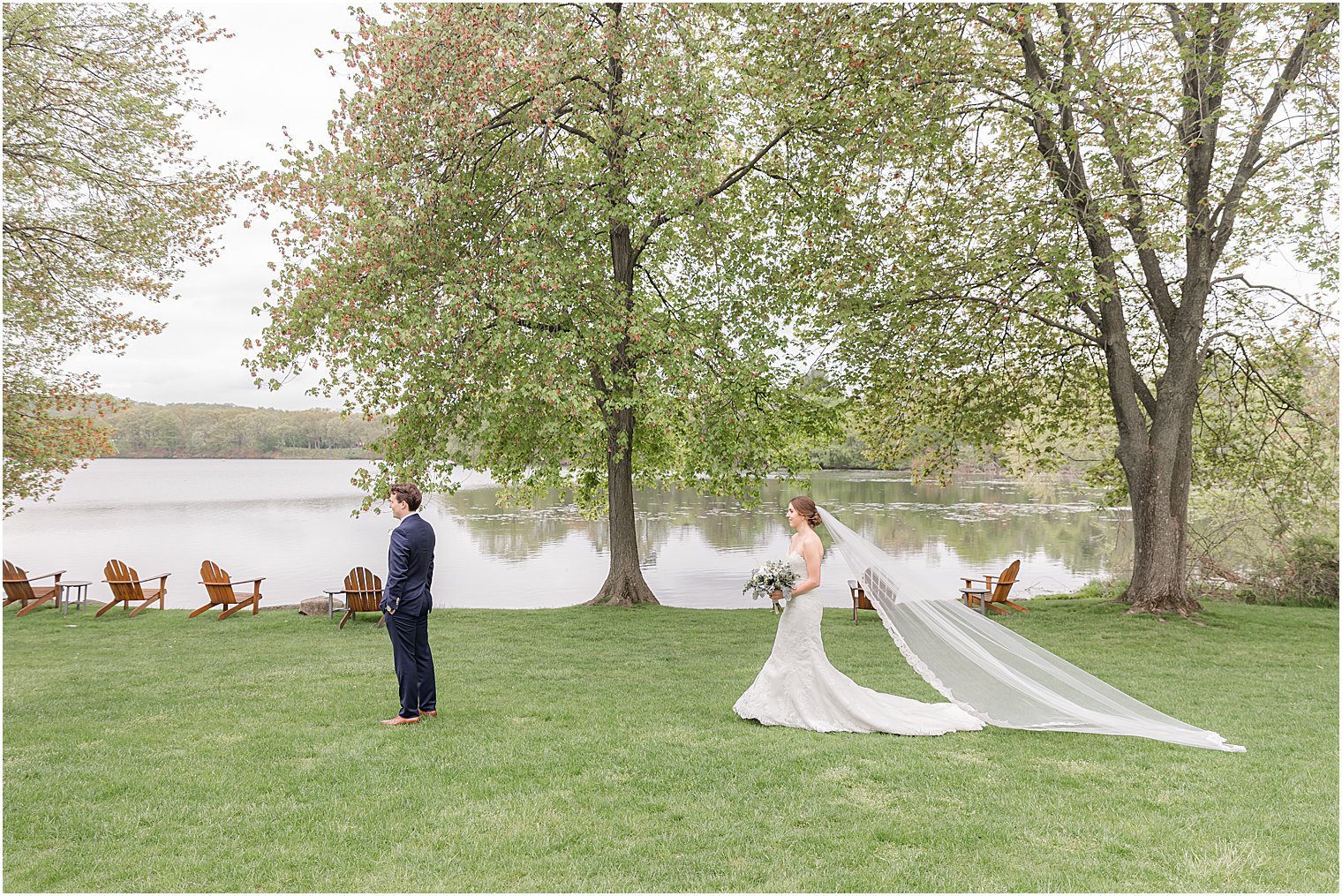 bride walks with veil trailing for first look