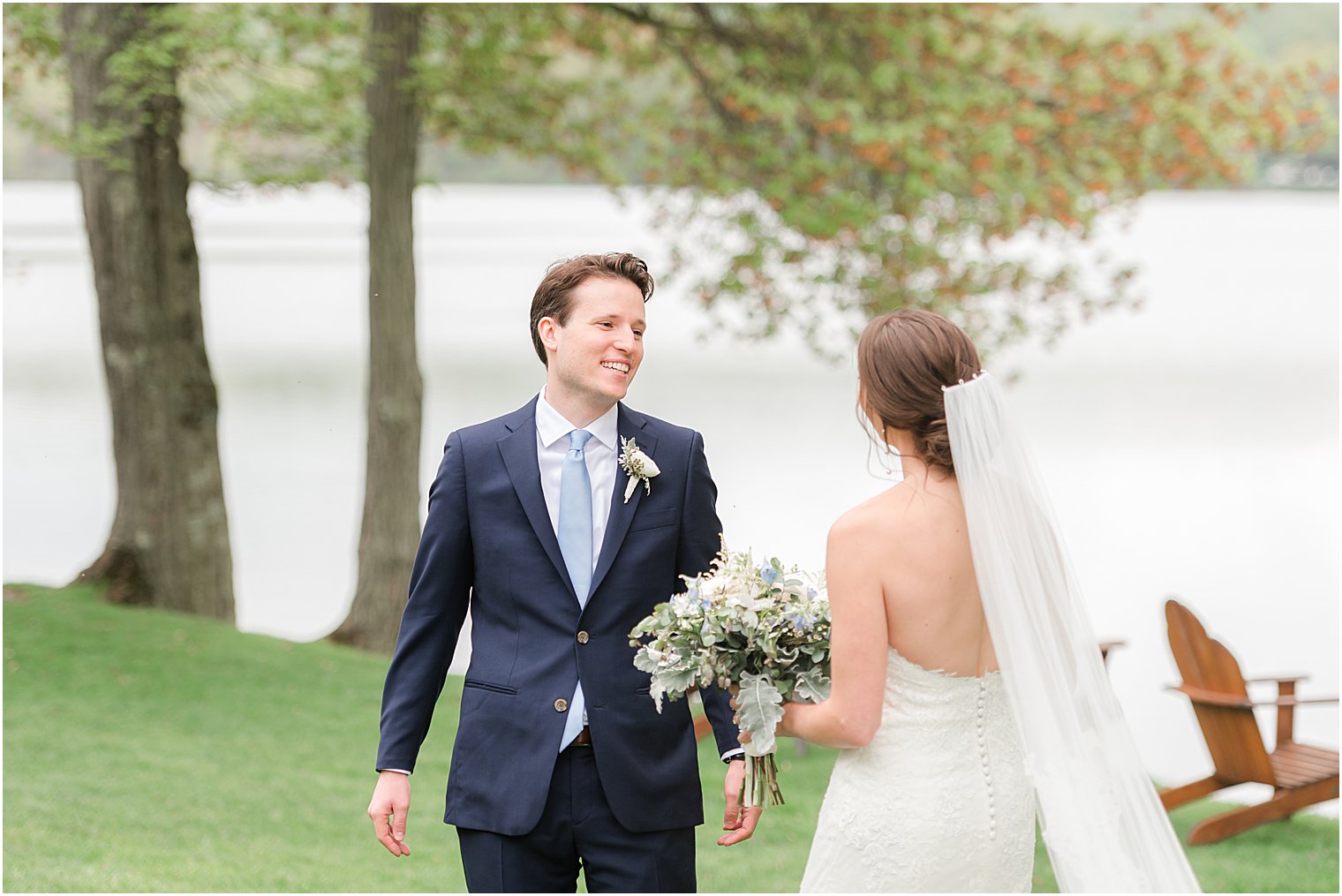 groom smiles at bride during first look at Indian Trail Club