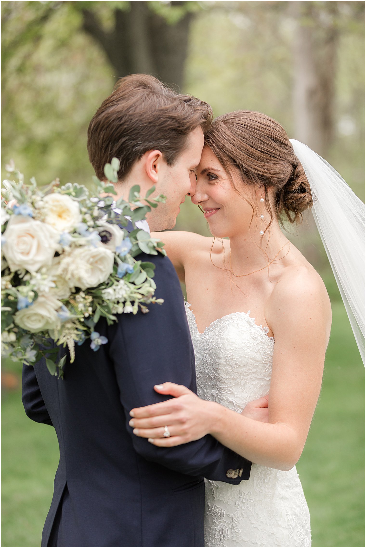 bride and groom pose with foreheads touching