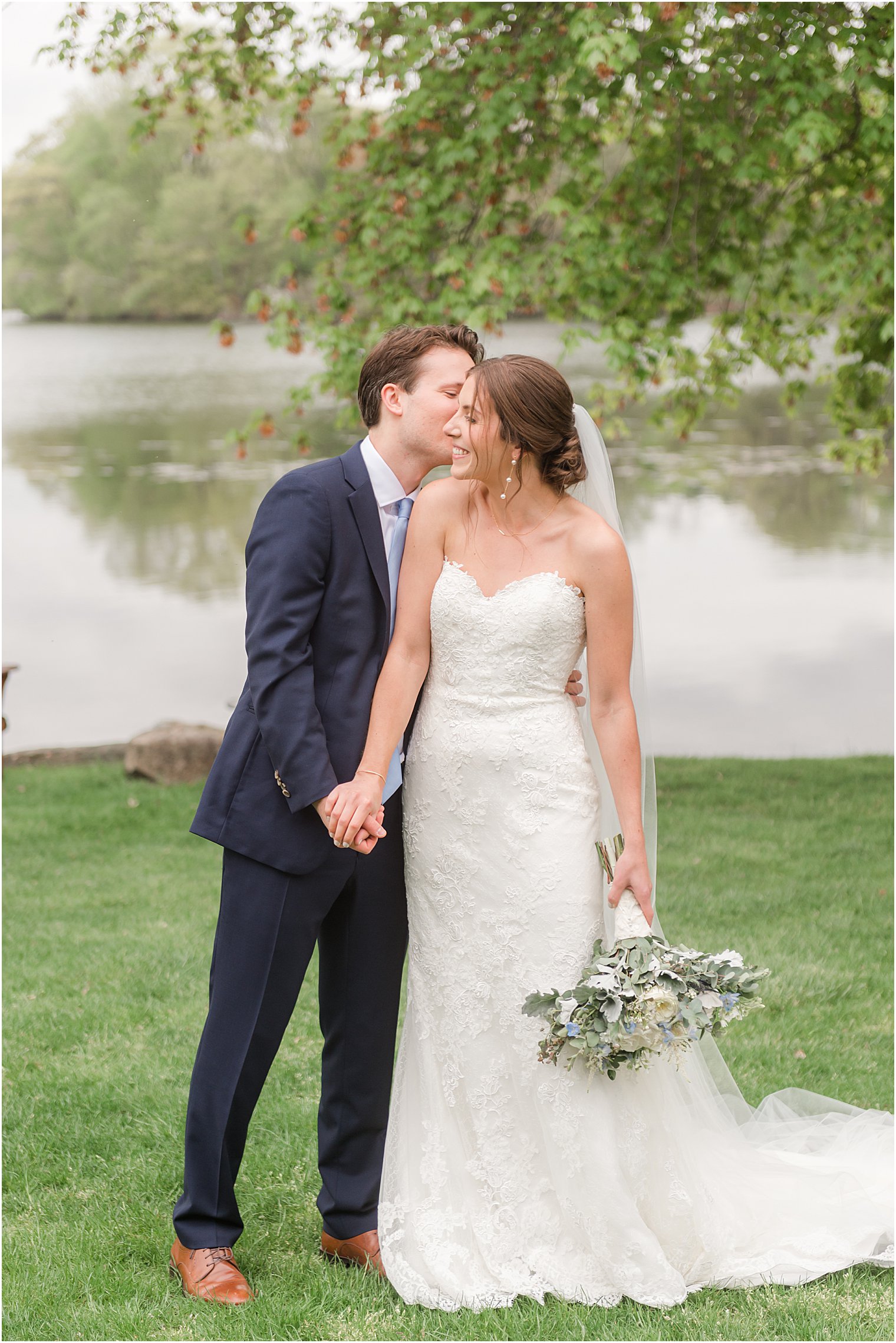 groom kisses bride's cheek during photos at Indian Trail Club