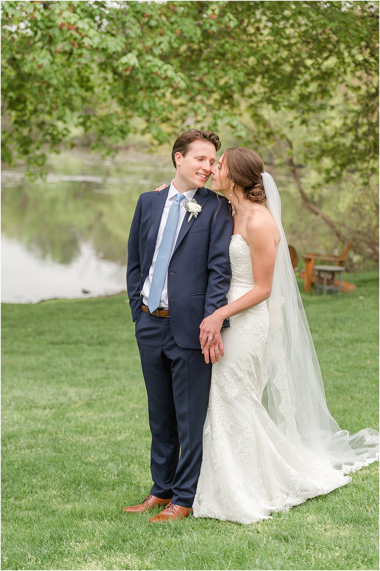 bride and groom hug on lawn at Indian Trail Club