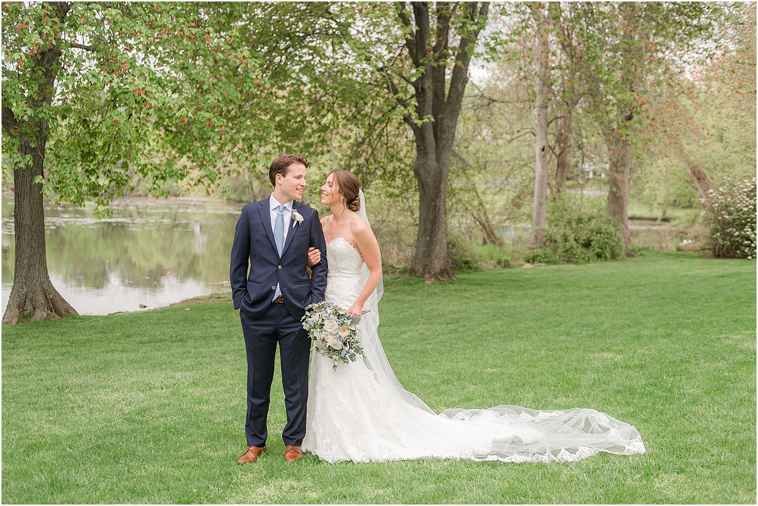 wedding portraits with bride's train behind her at Indian Trail Club