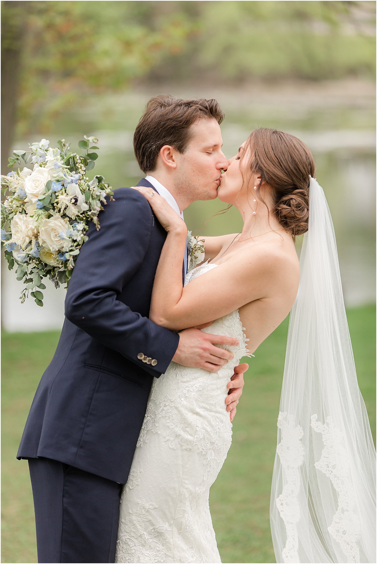 newlyweds kiss during NJ wedding portraits 