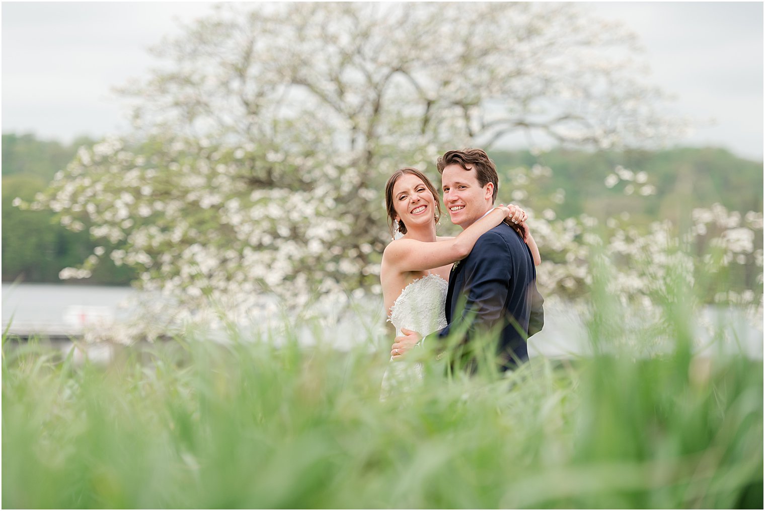 bride and groom hug by lake at Indian Trail Club