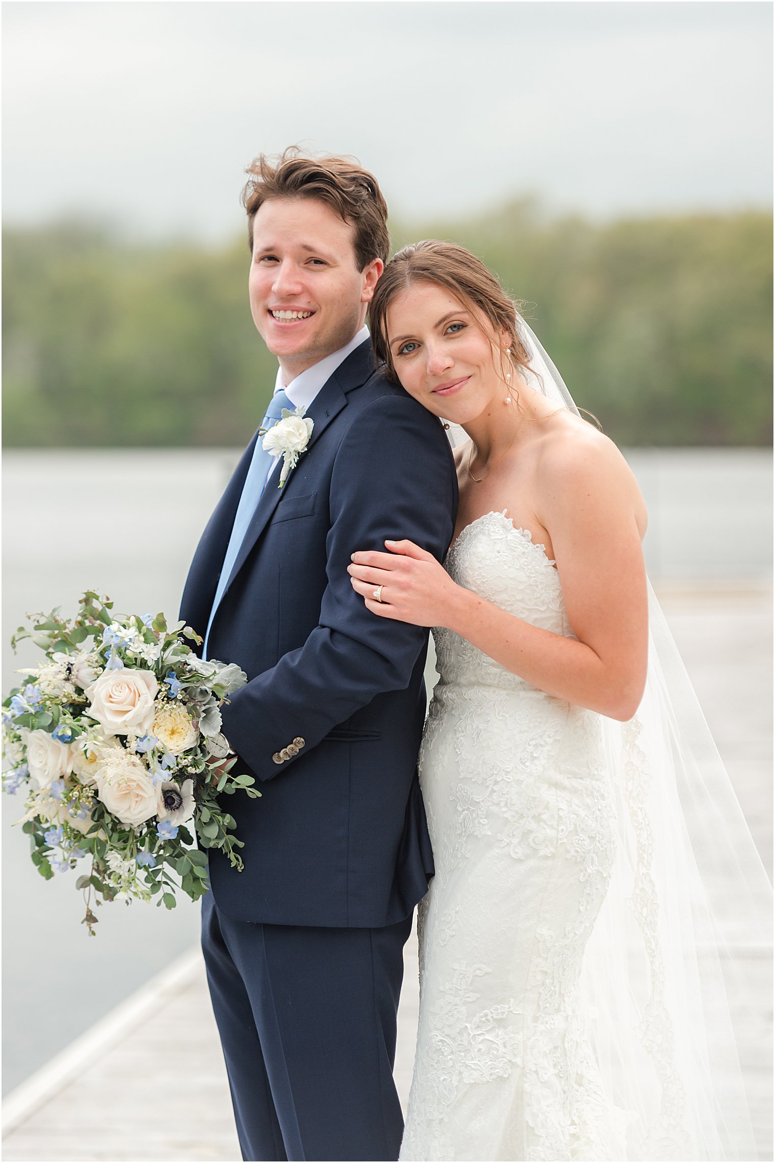 bride hugs groom's back during Nj wedding photos