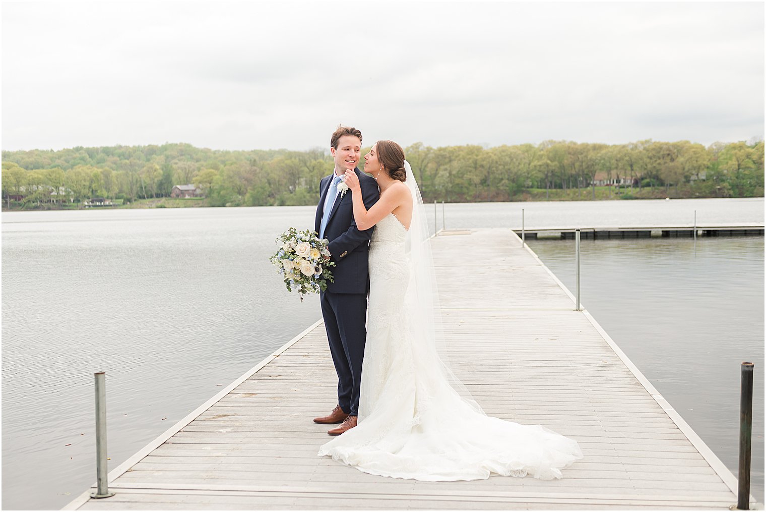 bride and groom pose on dock at Indian Trail Club