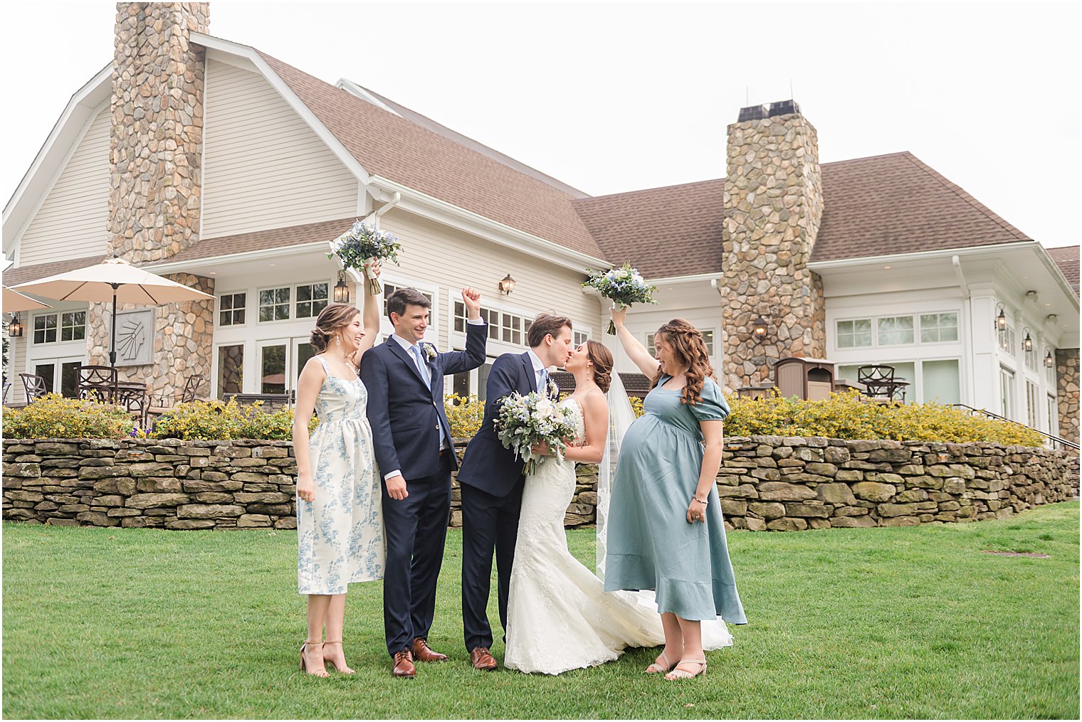 wedding party cheers with bride and groom