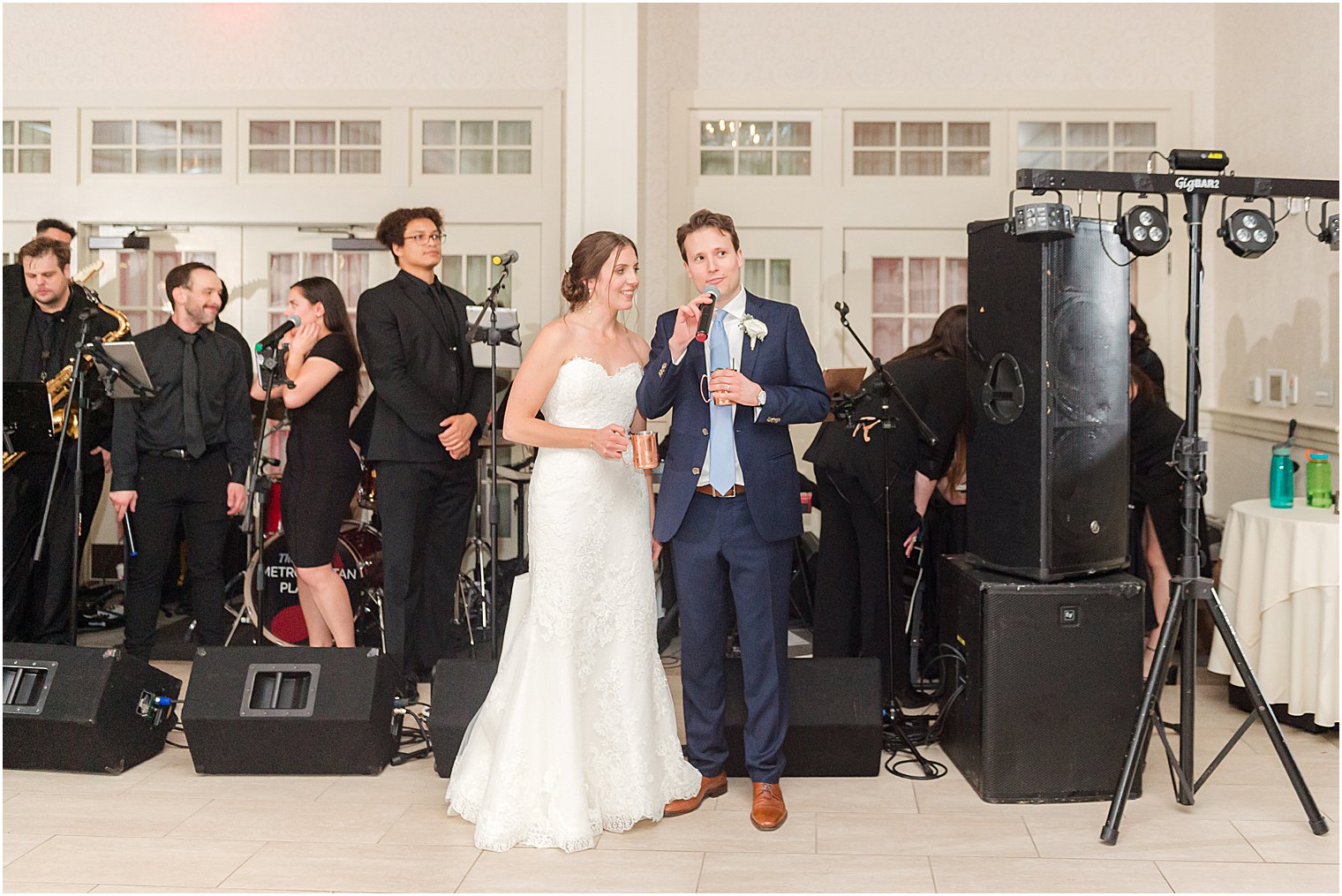 bride and groom stand with band for toast during Franklin NJ wedding reception