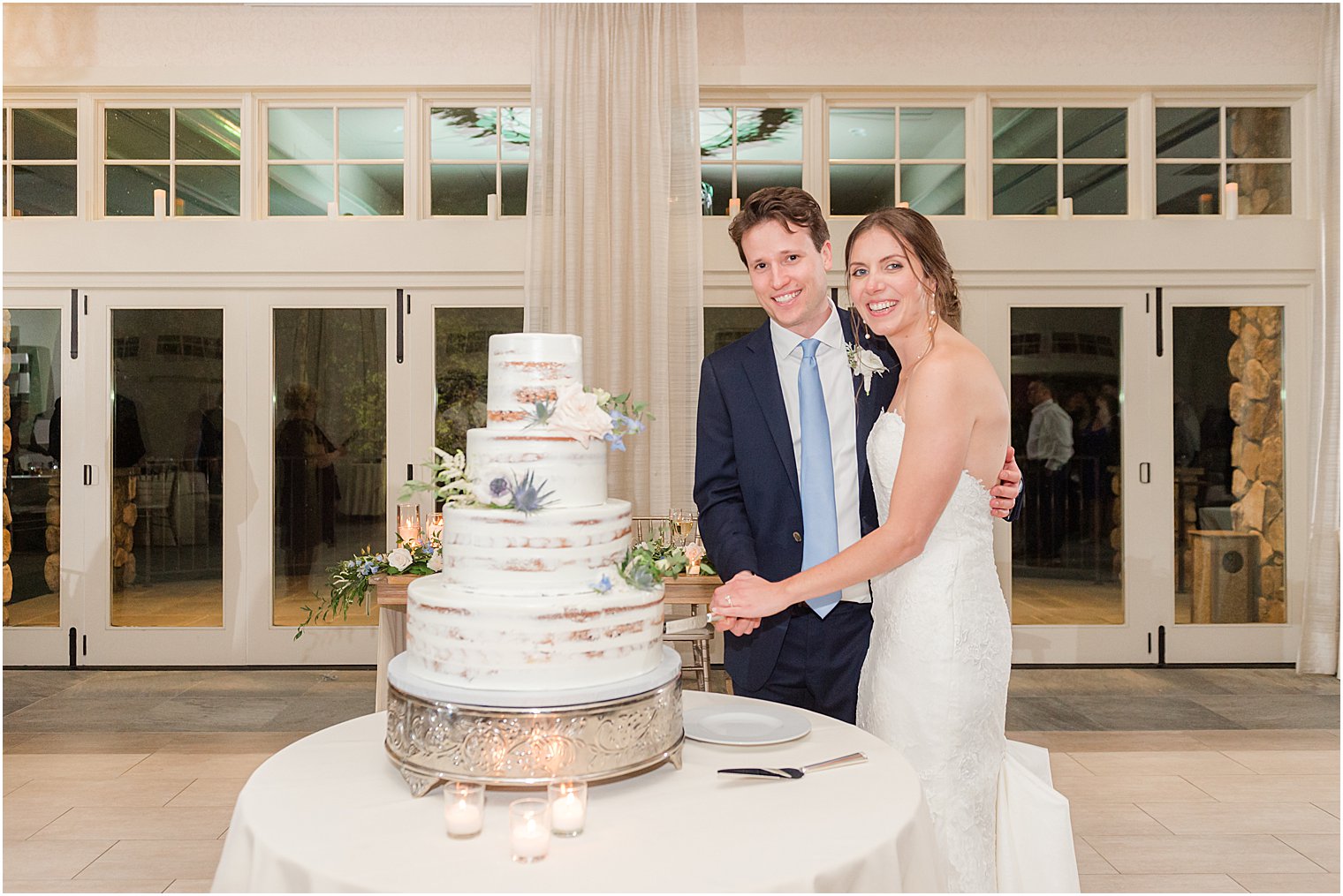 bride and groom cut wedding cake