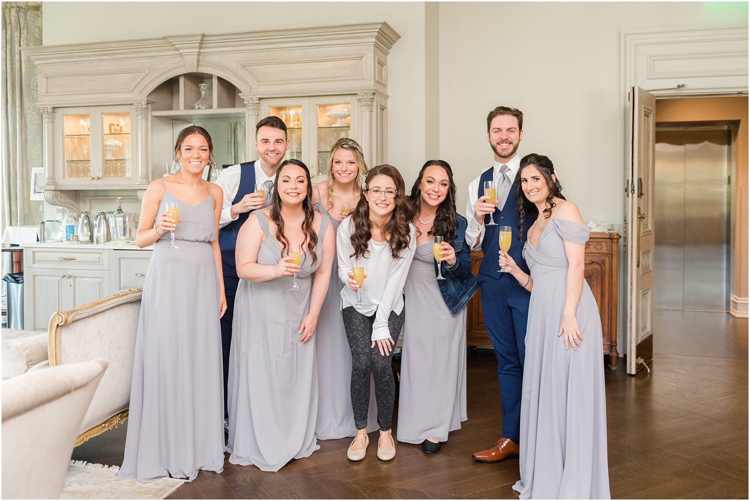 bride poses with bridal party in Park Chateau Estate bridal suite