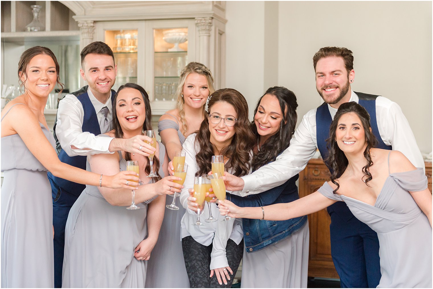 bride and bridal party toast champagne during NJ wedding day prep 