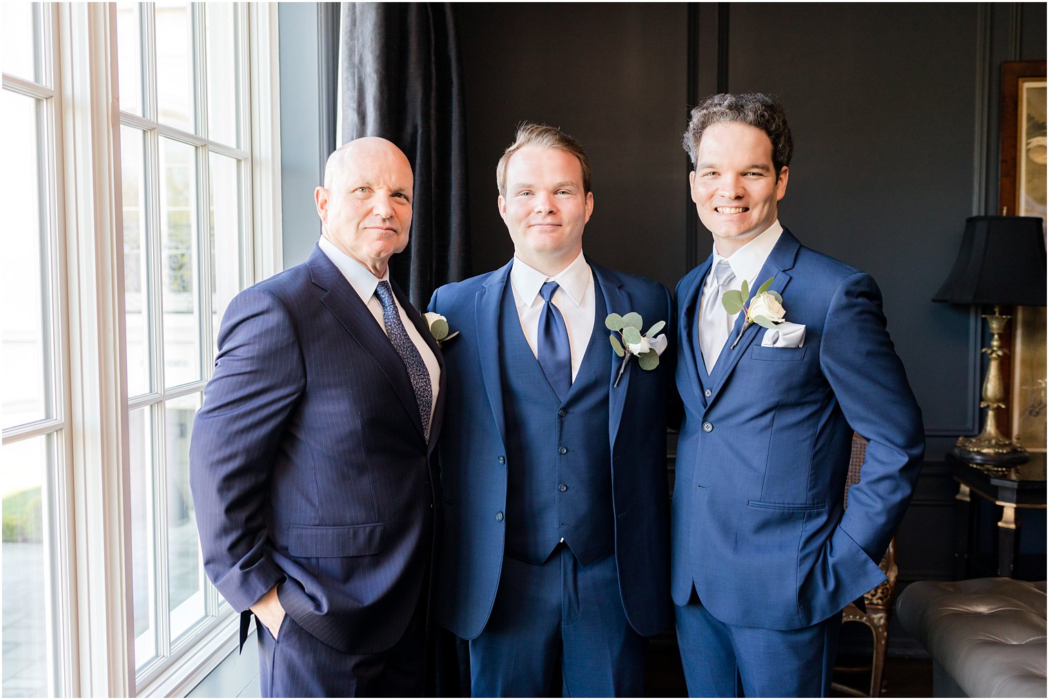 groom poses with dad during prep for Spring Park Chateau Estate wedding