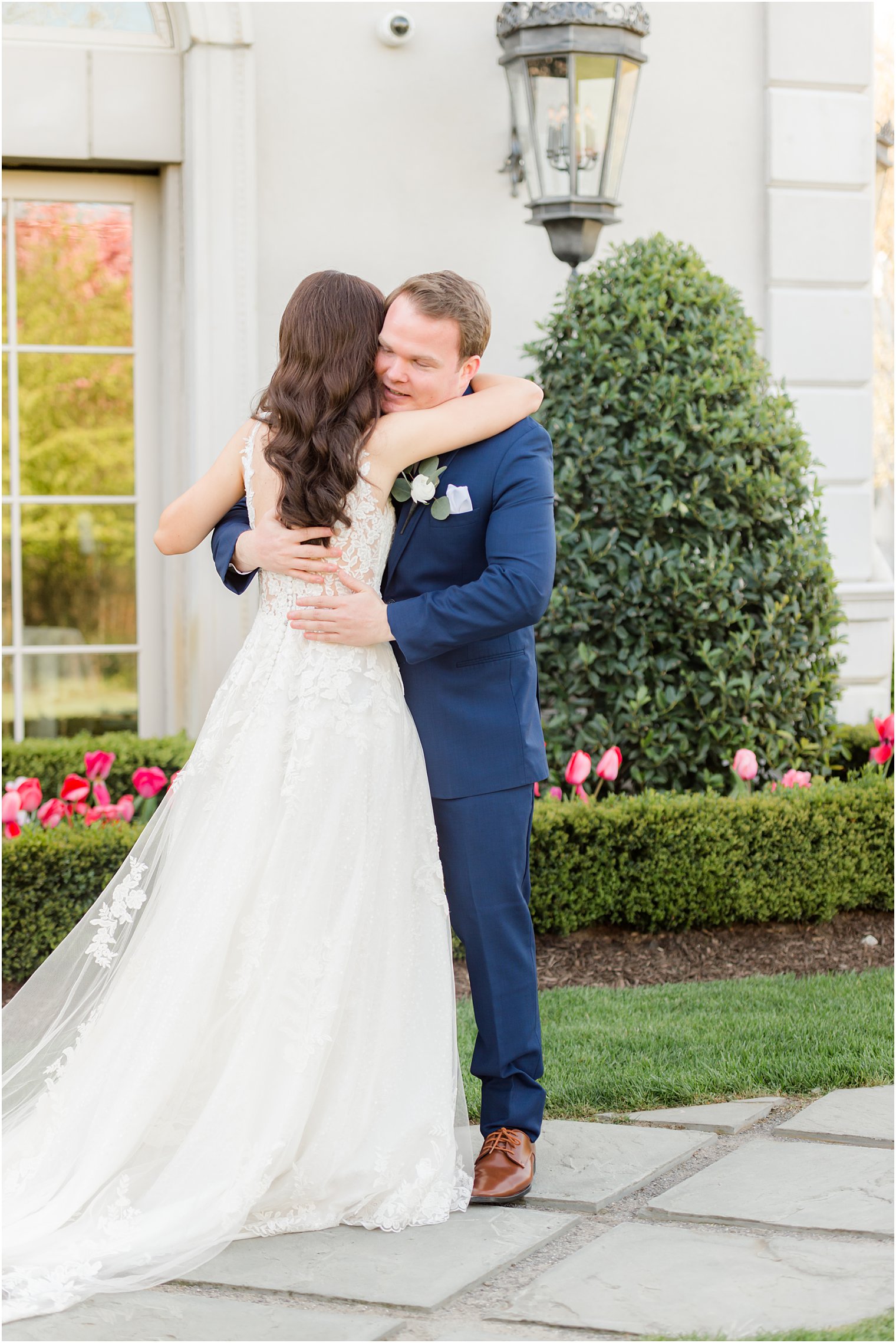 bride and groom hug during first look at Park Chateau Estate