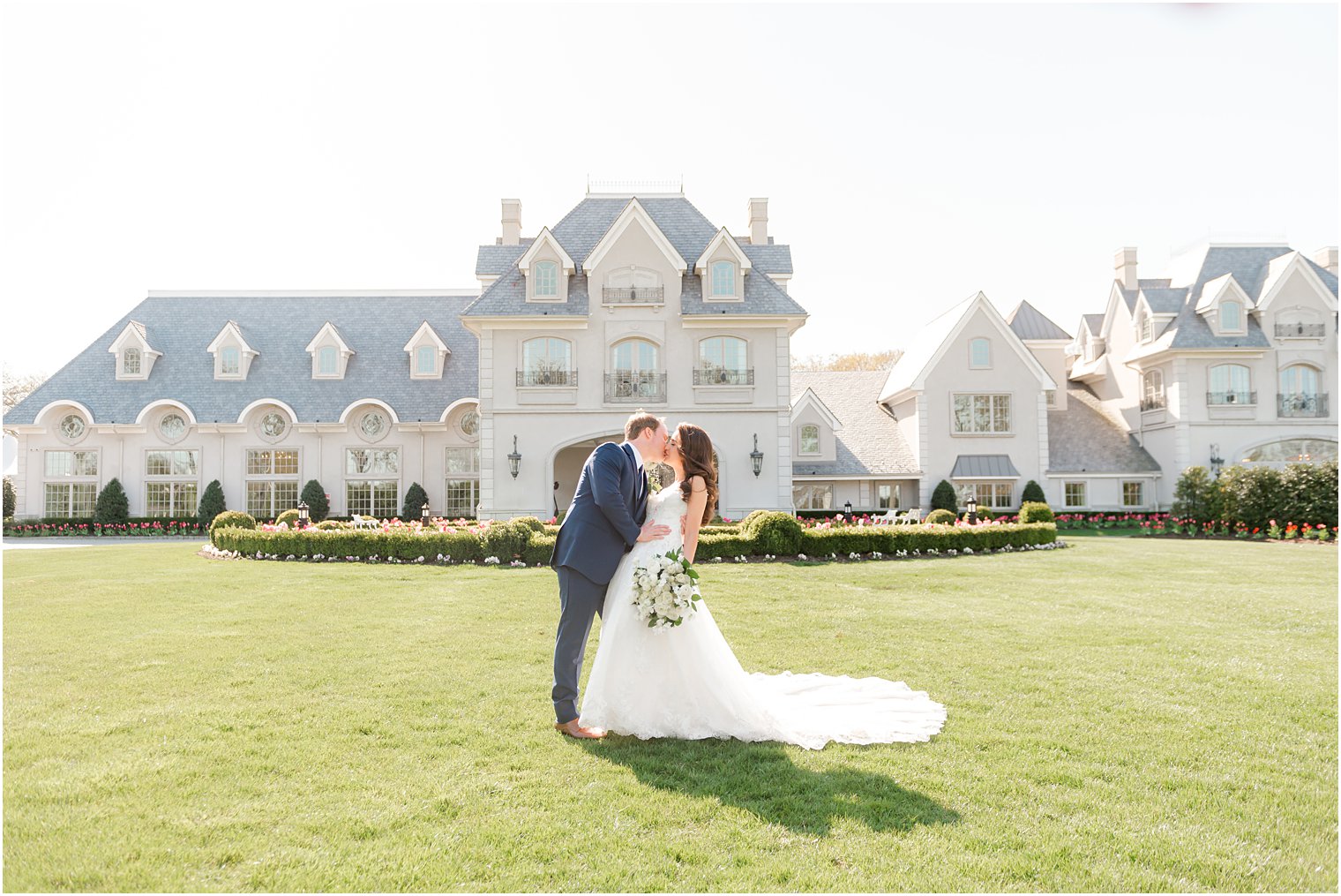 bride and from kiss on lawn outside Park Chateau Estate