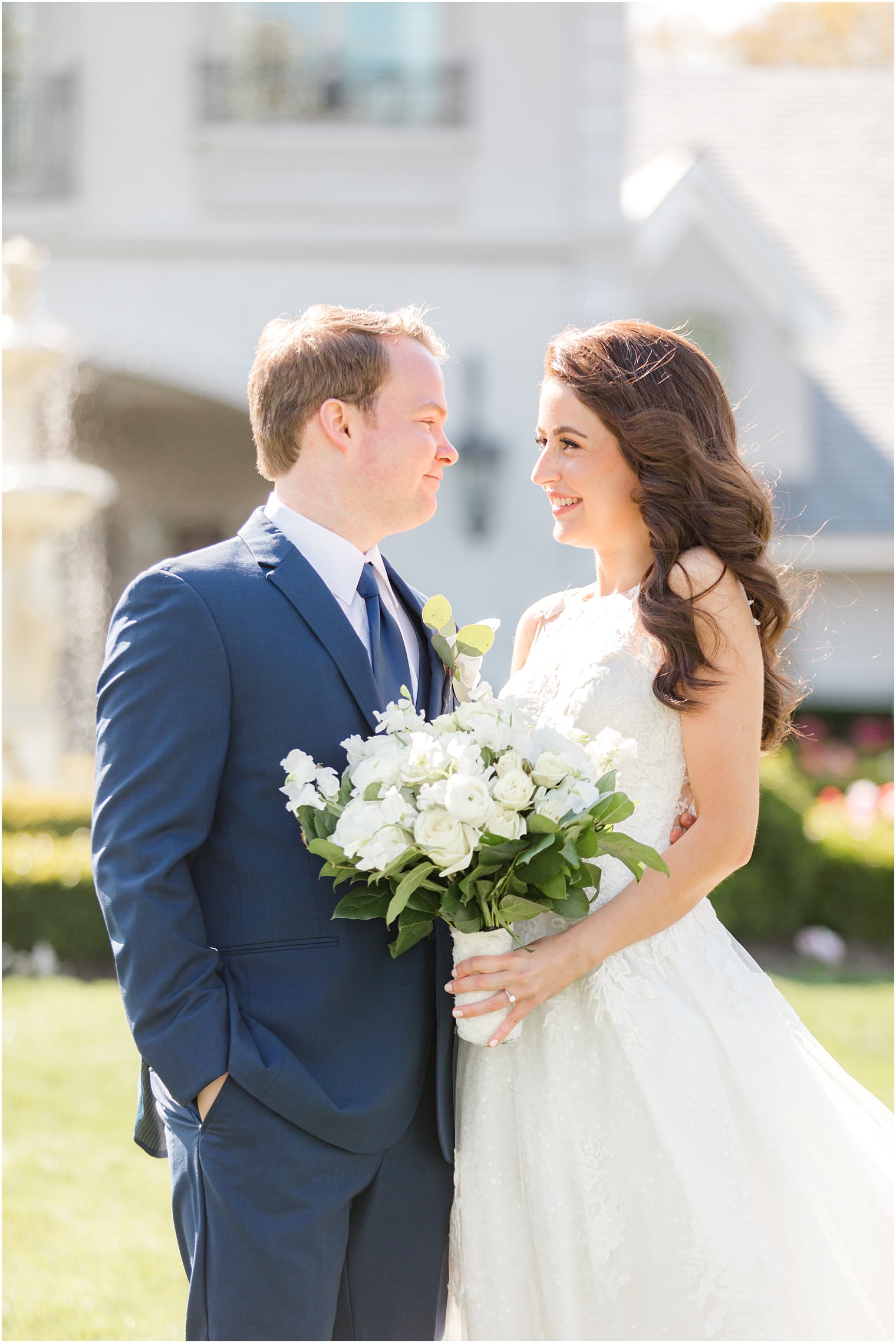 couple stand together holding bride's white bouquet in New Jersey 