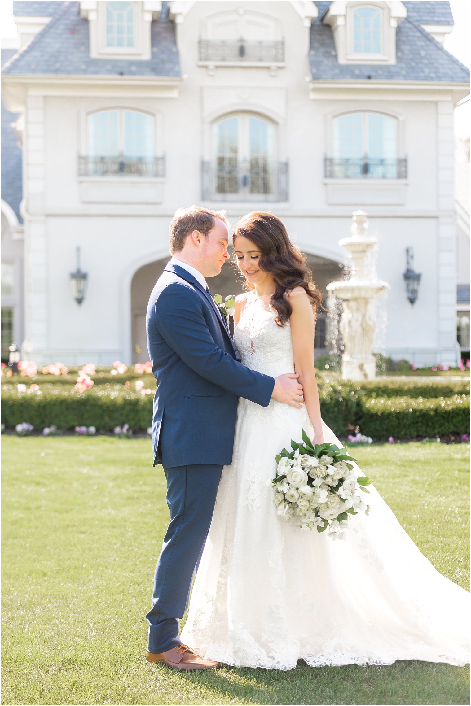 bride leans her head down while groom kisses her cheek