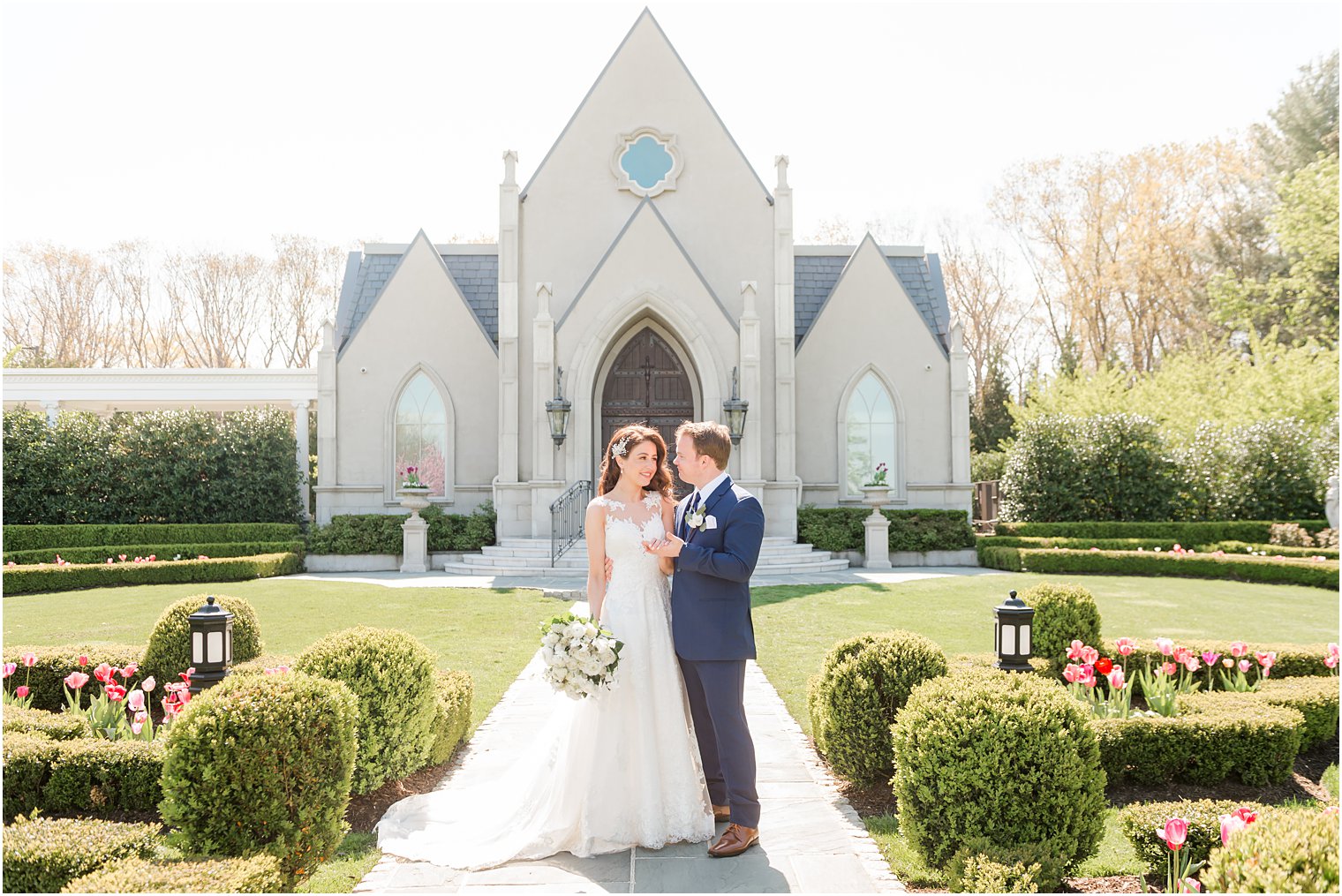 newlyweds pose outside chapel at Park Chateau