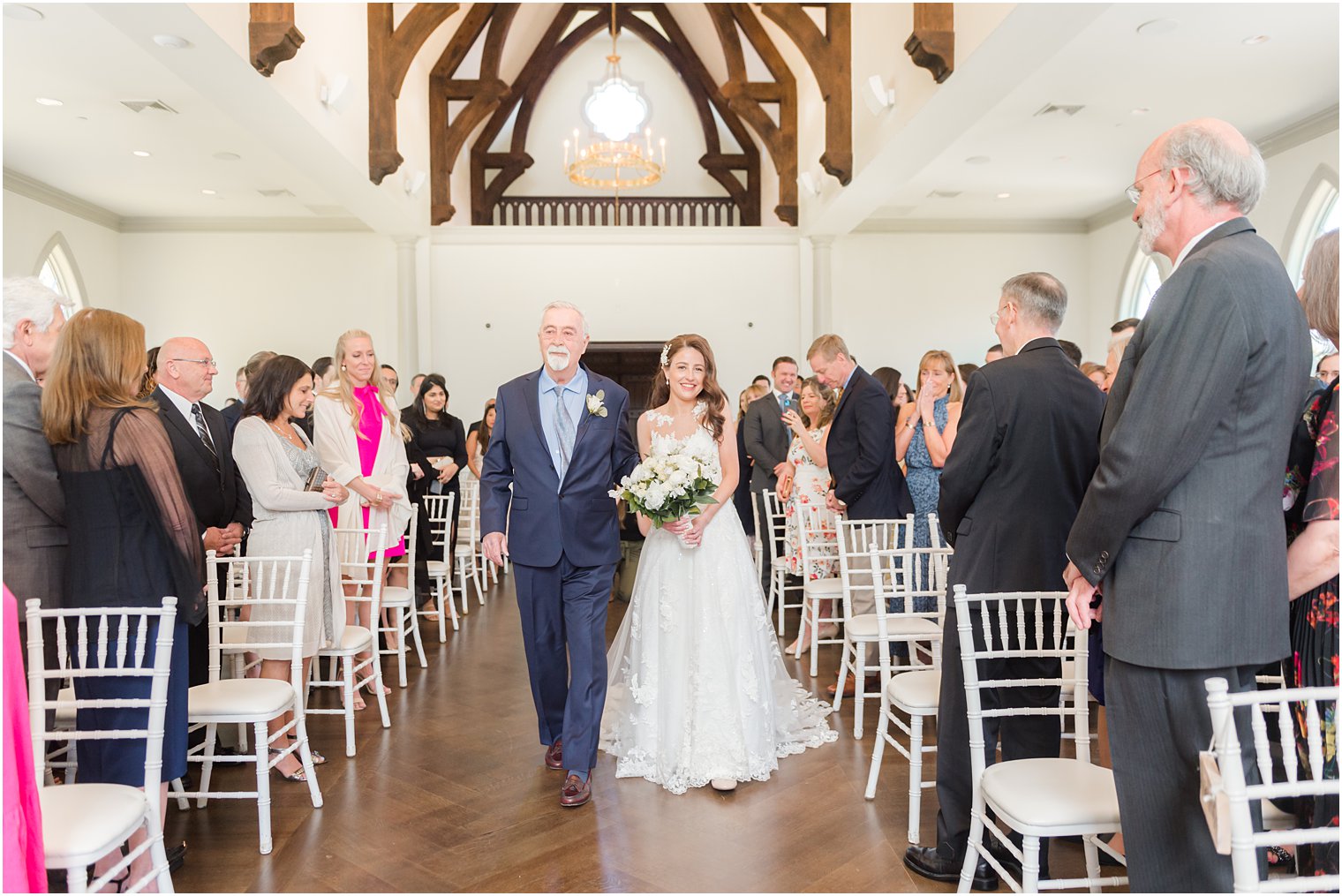 bride walks with dad down aisle at Park Chateau 