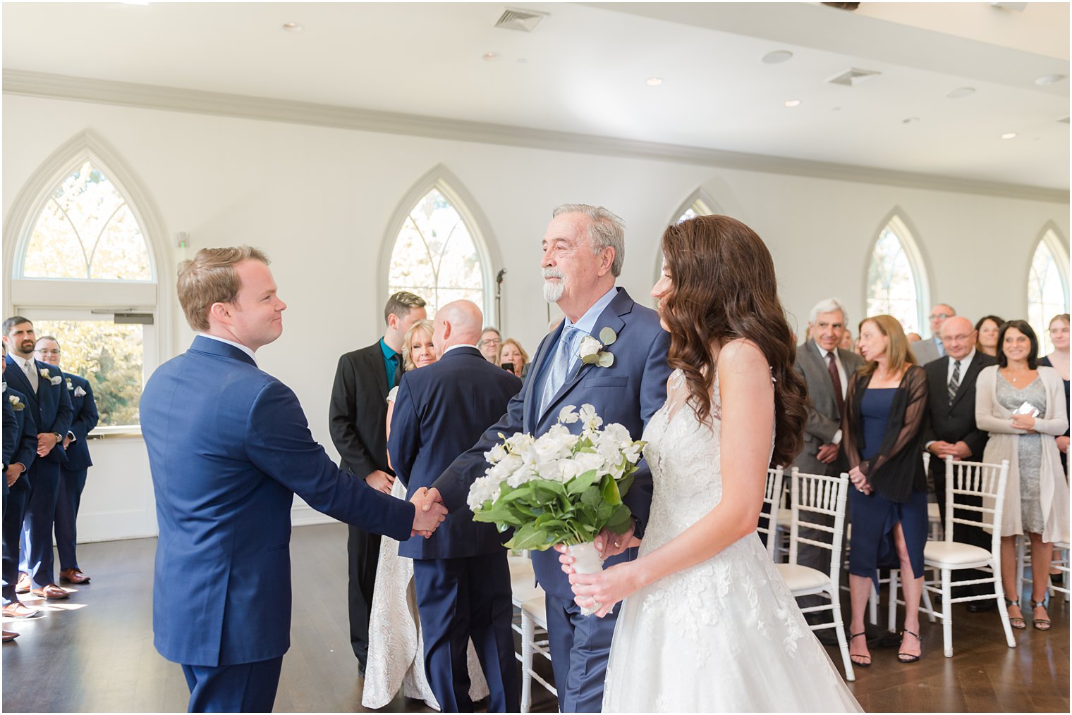 dad shakes groom's hand during New Jersey wedding ceremony