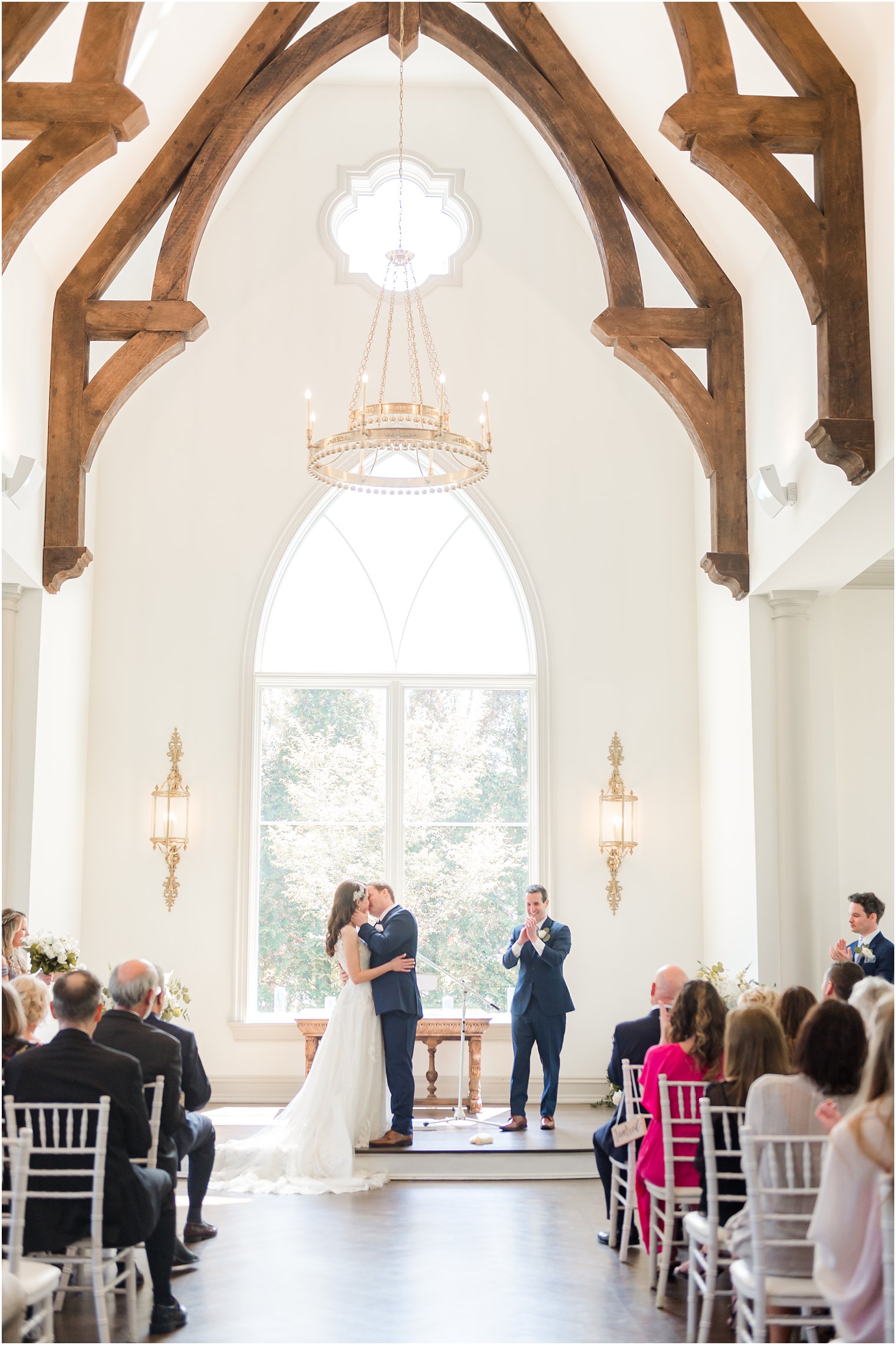 bride and groom kiss at altar during Park Chateau chapel