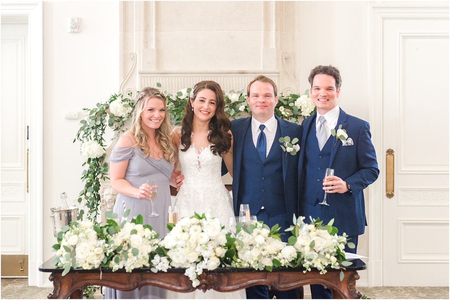 bride and groom pose with maid of honor and best man