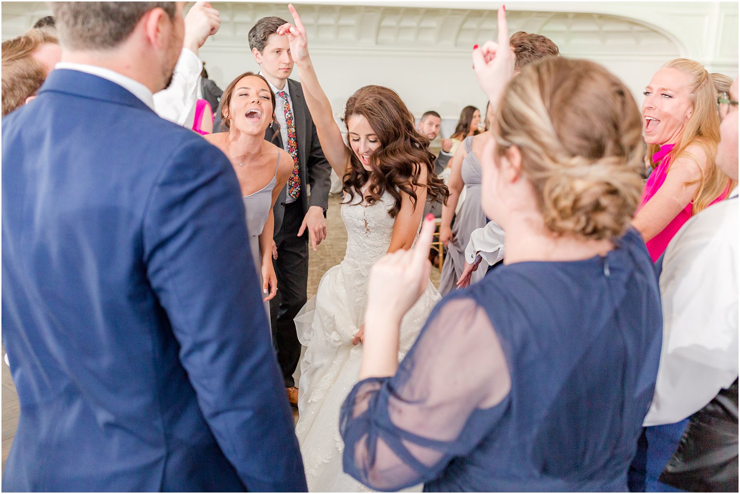 bride jumps with guests