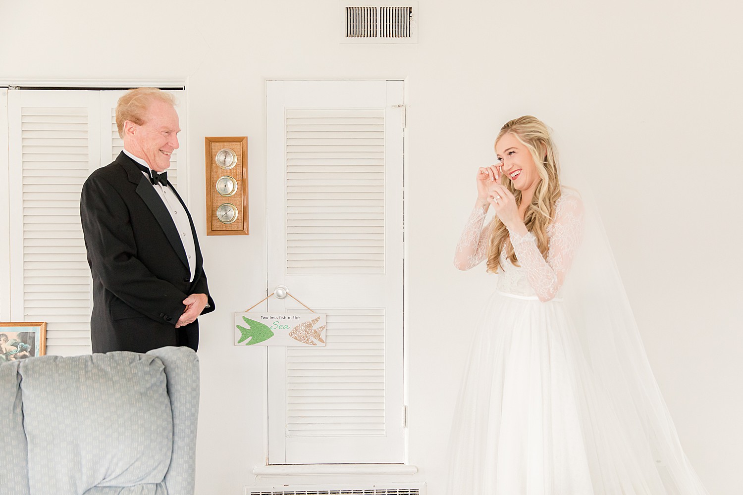 bride wipes away tears during first look with father
